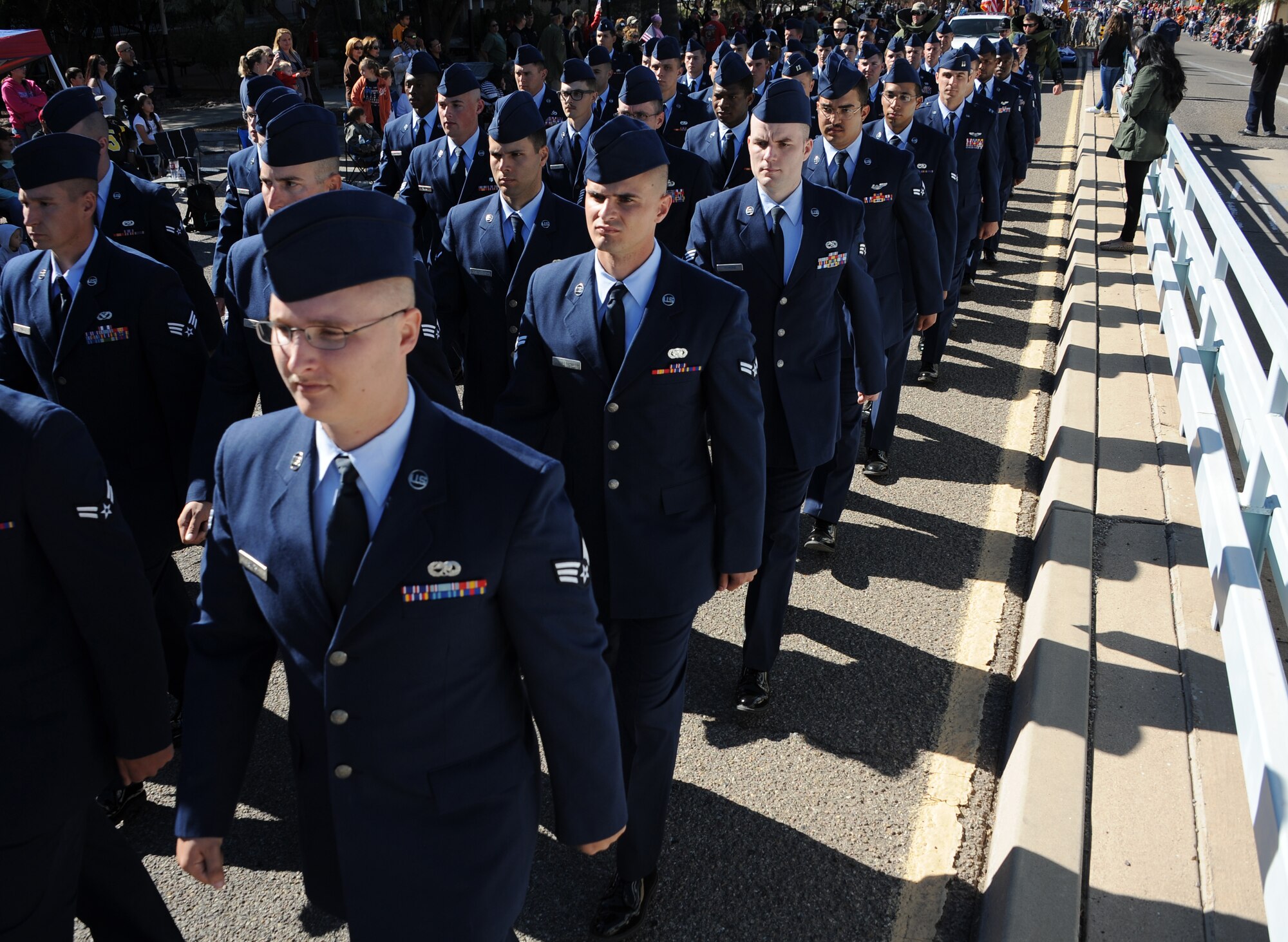 U.S. Airmen from Davis-Monthan Air Force Base march in formation in the Tucson Veterans Day Parade in downtown Tucson, Ariz., Nov. 11, 2015. More than 100 Airmen participated in the parade marching approximately two miles in an hour’s time. (U.S. Air Force photo by Airman 1st Class Ashley N. Steffen/Released)