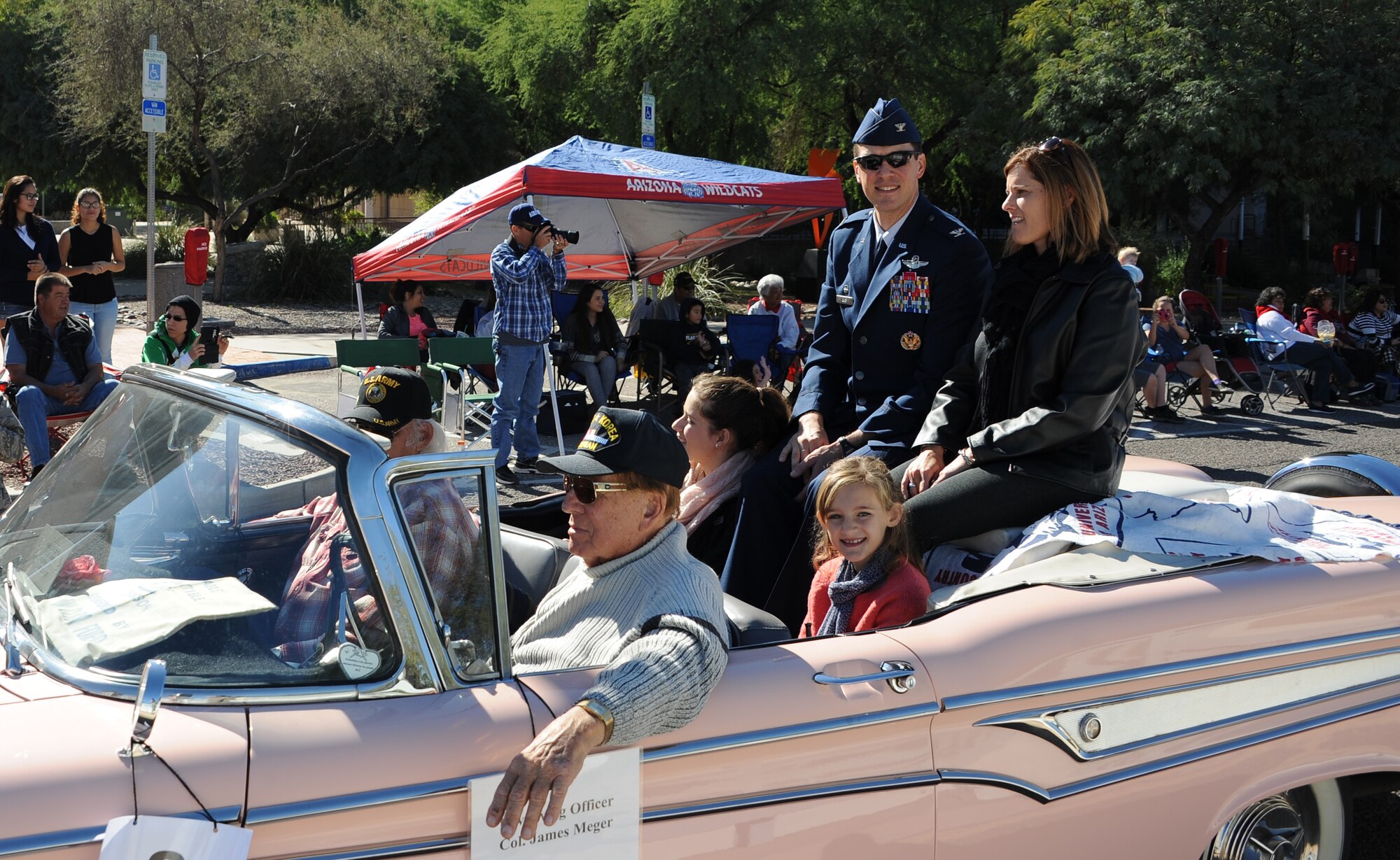 U.S. Air Force Col. James Meger, 355th Fighter Wing commander, and his family arrive at the Tucson Veterans Day Parade in downtown Tucson, Ariz., Nov. 11, 2015. Meger is responsible for one of the largest installations and flying operations in the Air Force with more than 100 aircraft, 7,500 Airmen and 3,200 civilians at Davis-Monthan Air Force Base. (U.S. Air Force photo by Airman 1st Class Ashley N. Steffen/Released)