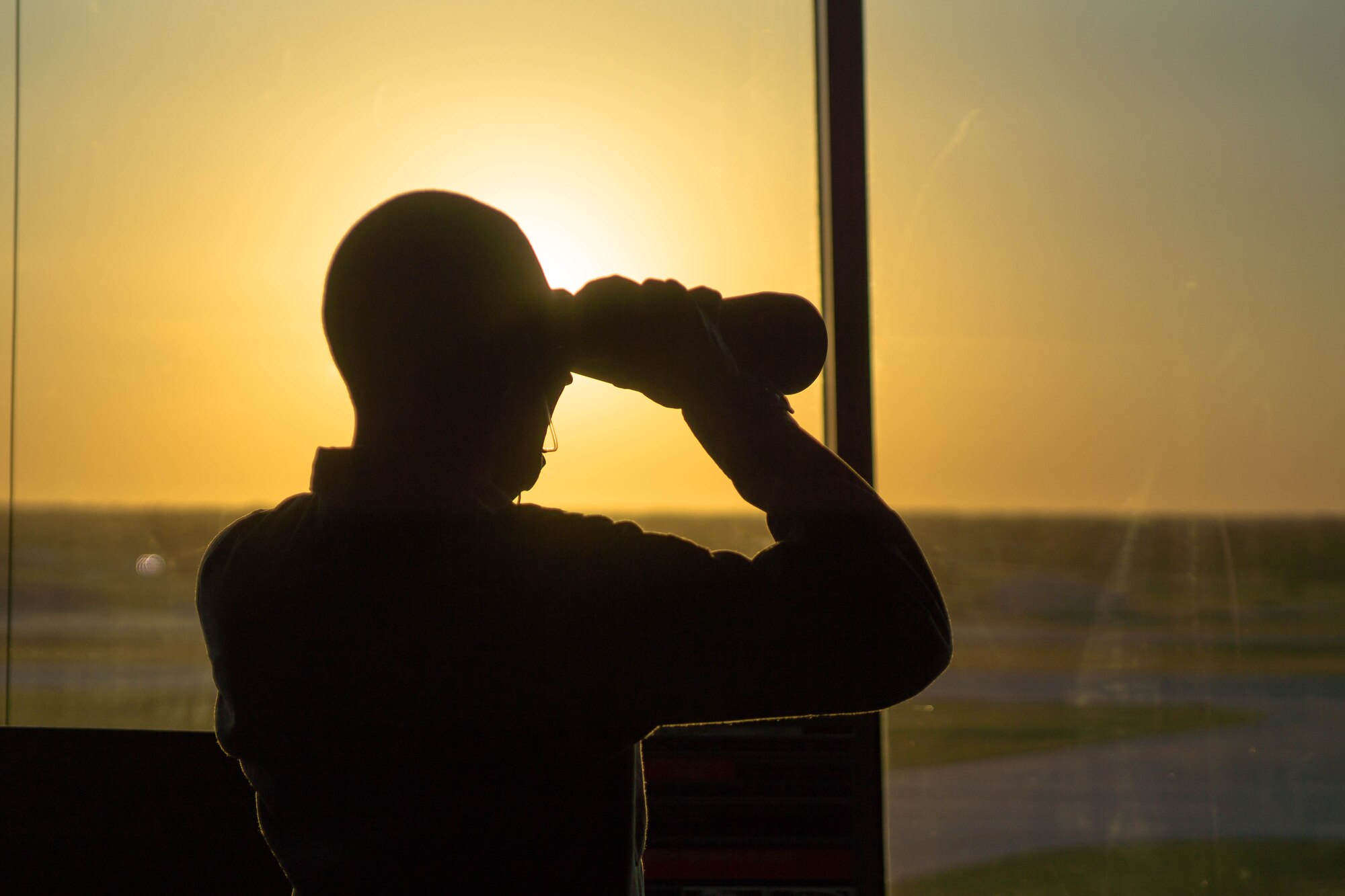 An air traffic controller looks onto the flightline, Oct. 15, 2015, at McConnell Air Force Base, Kan. ATC Airmen work around the clock by communicating and directing military and civilian aircraft to prevent mid-air collisions which could kill or injure many people and cost the Air Force its weapon systems . (U.S. Air Force photo/ Tech. Sgt. Jeffrey Mikell)