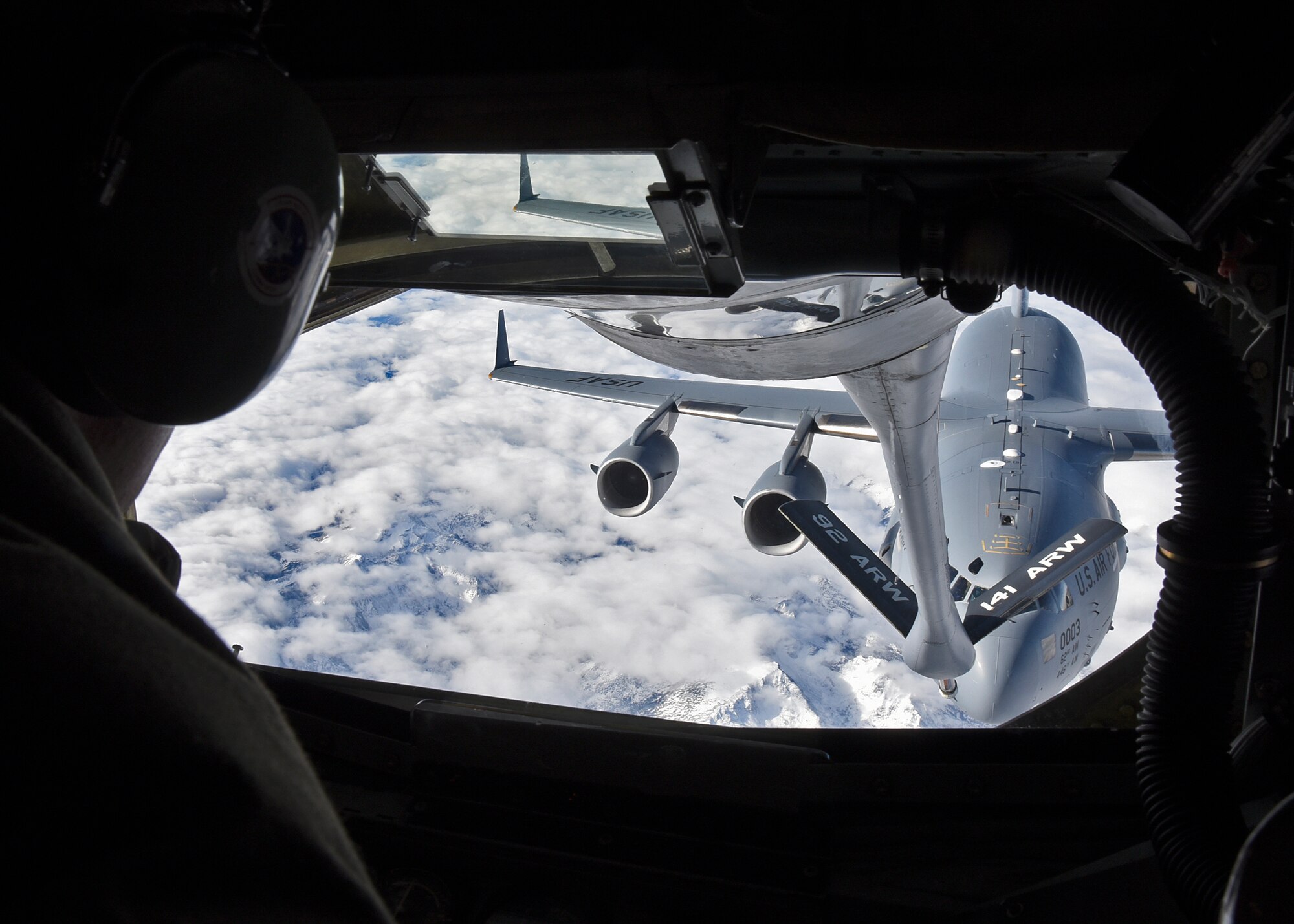 Staff Sgt. Gregory Albers, 93rd Air Refueling Squadron boom operator, refuels a C-17 Globemaster from Joint-Base Lewis McChord, Wash., during an orientation flight Nov. 12, 2015, at Fairchild AFB, Wash. The KC-135 Stratotanker was flown by Col. Brian McDaniel, 92nd Air Refueling Wing commander, with Maj. William Morse, 93rd ARS instructor pilot, and Capt. Christophe Fei, 93rd ARS pilot. (U.S. Air Force photo/Airman 1st Class Mackenzie Richardson)

