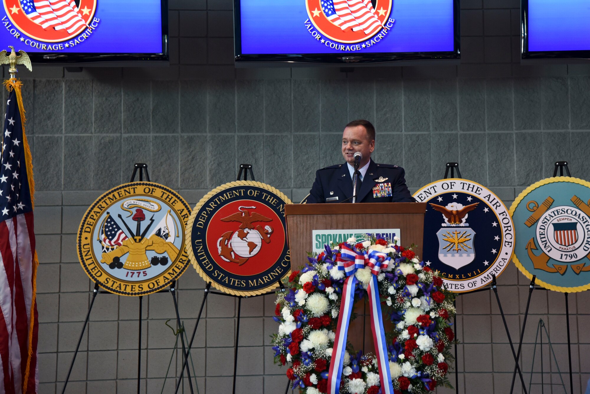 Col. Brian McDaniel, 92nd Air Refueling Wing commander, speaks to the Spokane community during a Veterans Day ceremony, Nov. 11, 2015, at the Spokane Veterans Memorial Arena in Spokane, Wash. Veterans Day is a day to honor America's veterans for their patriotism, love of country, willingness to serve and sacrifice for the common good. Fairchild Airmen visited several locations throughout Veterans Day to show appreciation and interact with veterans and their families. (U.S. Air Force photo/Senior Airman Janelle Patiño)