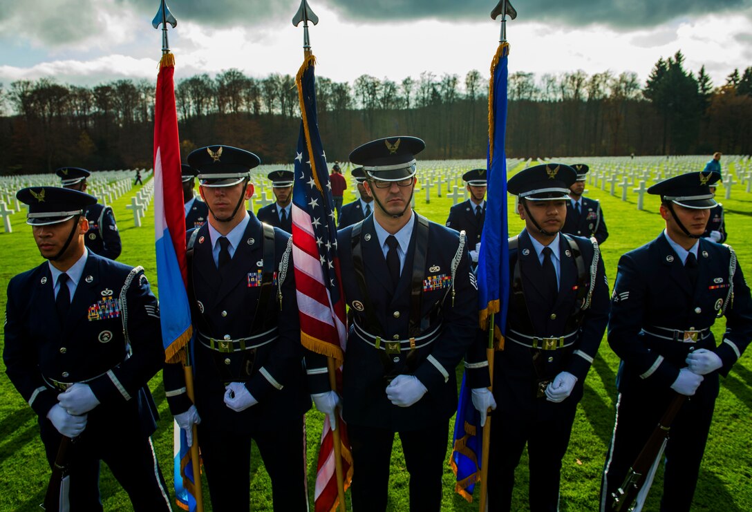 U.S. Air Force Honor Guardsmen stand attention in honor of fallen veterans during a wreath-laying ceremony at the Luxembourg American Cemetery and Memorial in Hamm, Luxembourg City, Luxembourg, Nov. 11, 2015. The cemetery rests 5,076 American service members and was administered by the American Battle Monuments Commission. (U.S. Air Force photo by Airman 1st Class Timothy Kim/Released)