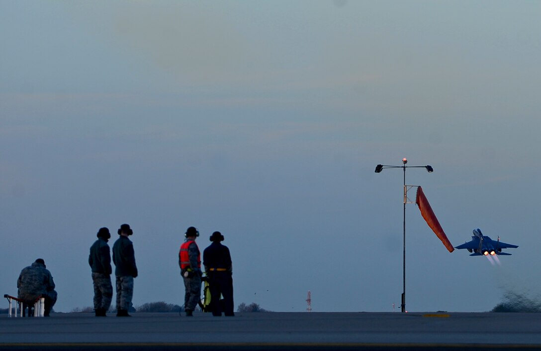 Airmen observe the departure of an F-15E Strike Eagle from RAF Lakenheath in support of Operation Inherent Resolve, Nov. 12, 2015. Aircraft from the 48th Fighter Wing deployed to Incirlik Air Base, Turkey, to conduct counter-ISIL missions in Iraq and Syria.  This dual-role fighter jet is designed to perform air-to-air and air-to-ground missions in all weather conditions. (U.S. Air Force photo by Senior Airman Erin Trower/Released)