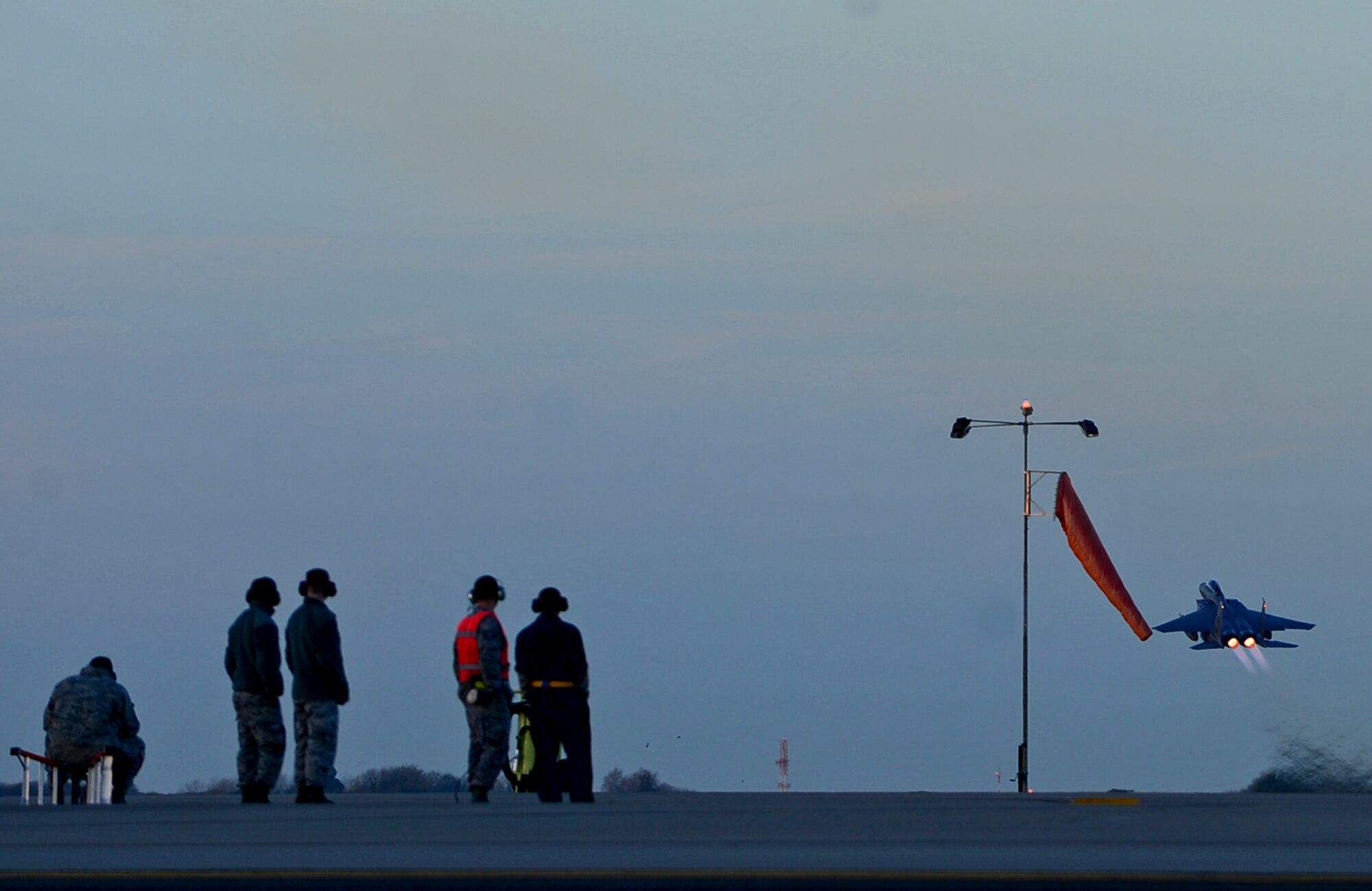 Airmen observe the departure of an F-15E Strike Eagle from RAF Lakenheath in support of Operation Inherent Resolve, Nov. 12, 2015. Aircraft from the 48th Fighter Wing deployed to Incirlik Air Base, Turkey, to conduct counter-ISIL missions in Iraq and Syria.  This dual-role fighter jet is designed to perform air-to-air and air-to-ground missions in all weather conditions. (U.S. Air Force photo by Senior Airman Erin Trower/Released)