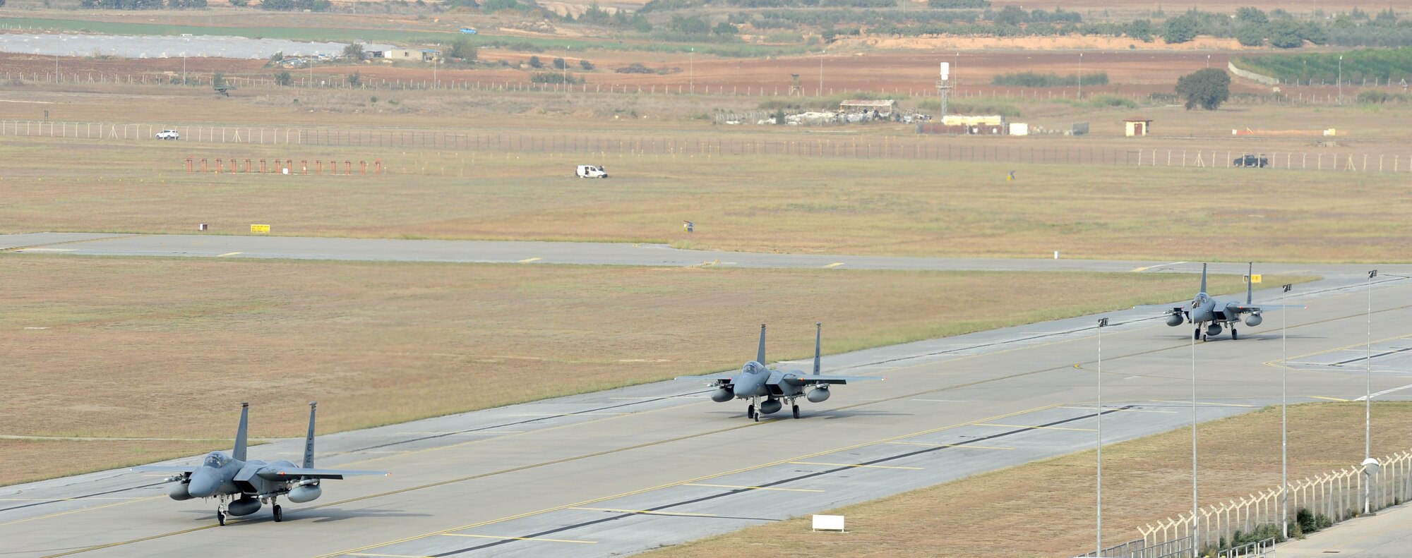 Three F-15C Eagles from the 493rd Fighter Squadron at RAF Lakenheath, UK, taxi the flight line at Incirlik Air Base, Turkey, Nov. 6, 2015. Six F-15Cs are deployed to conduct combat air patrols in Turkish air space. (U.S. Air Force photo by Tech. Sgt. Taylor Worley/Released)