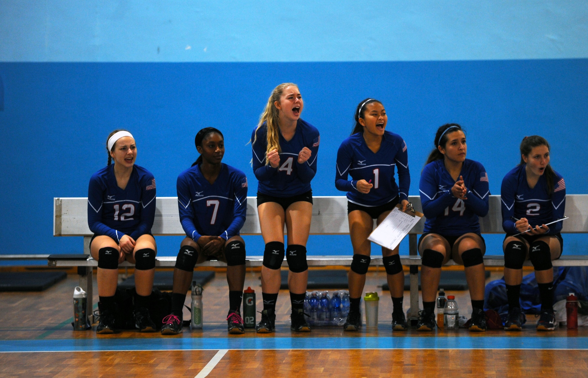 Members of the Ramstein Royals volleyball team cheer for teammates during the Department of Defense Dependents Schools European volleyball championships Nov. 7, 2015, at Ramstein Air Base, Germany. Ramstein was one of 26 teams from three divisions competing in the DODDS European volleyball championships. (U.S. Air Force photo/Staff Sgt. Sharida Jackson)