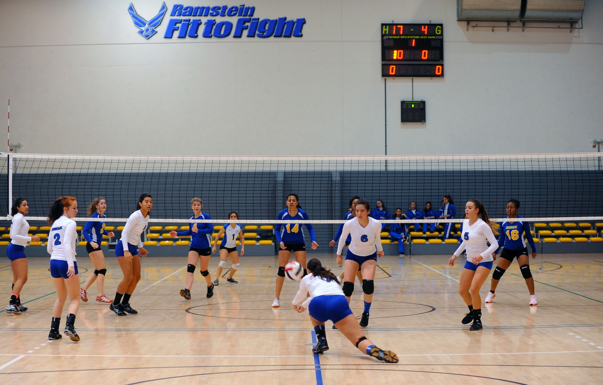 The Incirlik Hodjas, white jerseys, compete against the Ansbach Cougars during the Department of Defense Dependents Schools European volleyball championships Nov. 7, 2015, at Ramstein Air Base, Germany. Twenty-six teams from three divisions competed in the DODDS European volleyball championships. The DODDS school system is designed for military children residing overseas. (U.S. Air Force photo/Staff Sgt. Sharida Jackson)