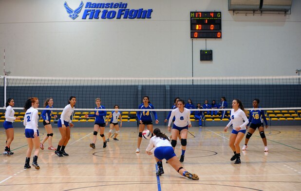The Incirlik Hodjas, white jerseys, compete against the Ansbach Cougars during the Department of Defense Dependents Schools European volleyball championships Nov. 7, 2015, at Ramstein Air Base, Germany. Twenty-six teams from three divisions competed in the DODDS European volleyball championships. The DODDS school system is designed for military children residing overseas. (U.S. Air Force photo/Staff Sgt. Sharida Jackson)