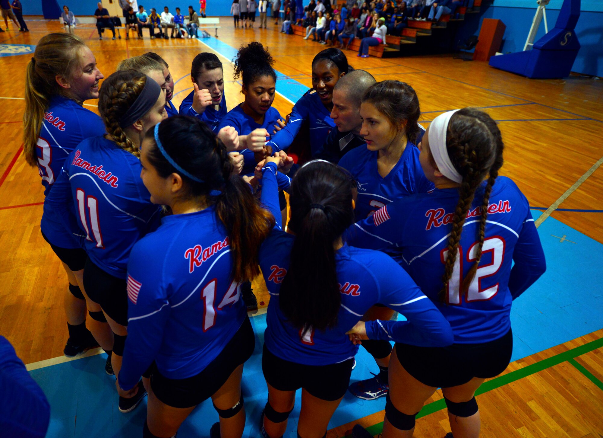 Members of the Ramstein Royals volleyball team huddle before their match during the Department of Defense Dependents Schools European volleyball championships Nov. 7, 2015, at Ramstein Air Base, Germany. Ramstein was one of 26 teams from three divisions competing in the DODDs European volleyball championships. (U.S. Air Force photo/Staff Sgt. Sharida Jackson)