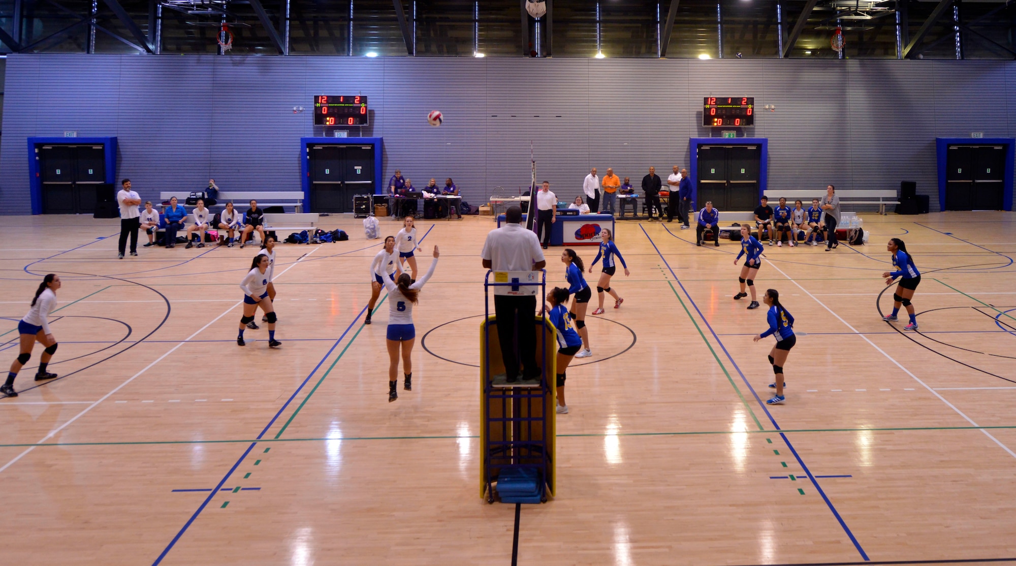 The Incirlik Hodjas, white jerseys, compete against the Ansbach Cougars during the Department of Defense Dependents Schools European volleyball championships Nov. 7, 2015, at Ramstein Air Base, Germany. Twenty-six teams from three divisions competed in the DODDS European volleyball championships. The DODDS school system is designed for military children residing overseas. (U.S. Air Force photo/Staff Sgt. Sharida Jackson)