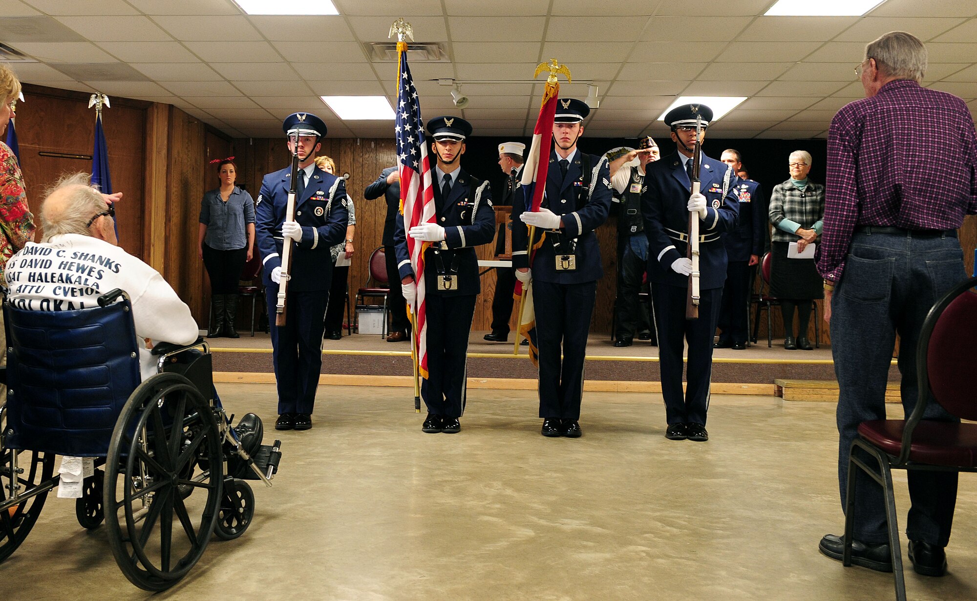 Members of the Whiteman Air Force Base Honor Guard present the colors during the singing of the National Anthem at the American Legion in Warrensburg, Mo., Nov. 11, 2015. The event celebrated veterans who have contributed to American history. Attendees had the opportunity to meet with “Rosie the Riveter,” as well as current and past service members. (U.S. Air Force photo by Airman 1st Class Jazmin Smith)