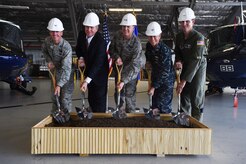 From left to right, Col. Brad Hoagland, Joint Base Andrews/11th Wing commander, Mark Higby, Haskell Corporation senior vice president, Maj. Gen. Darryl Burke, Air Force District of Washington/320th Air Expeditionary Wing commander, U.S. Navy Capt. Frederick Burgess, Naval Facilities Engineering Command Washington commanding officer/Naval District Washington regional engineer, and Col. Fred Koegler, 811th Operations Group commander, pose during a ground breaking ceremony for the 811 Operations Group at Joint Base Andrews, Md., Nov. 12, 2015. The new facility will provide space for mission planning, briefing, training, flight simulation, operations and administration. (U.S. Air Force photo by Senior Airman Joshua R. M. Dewberry/Released)