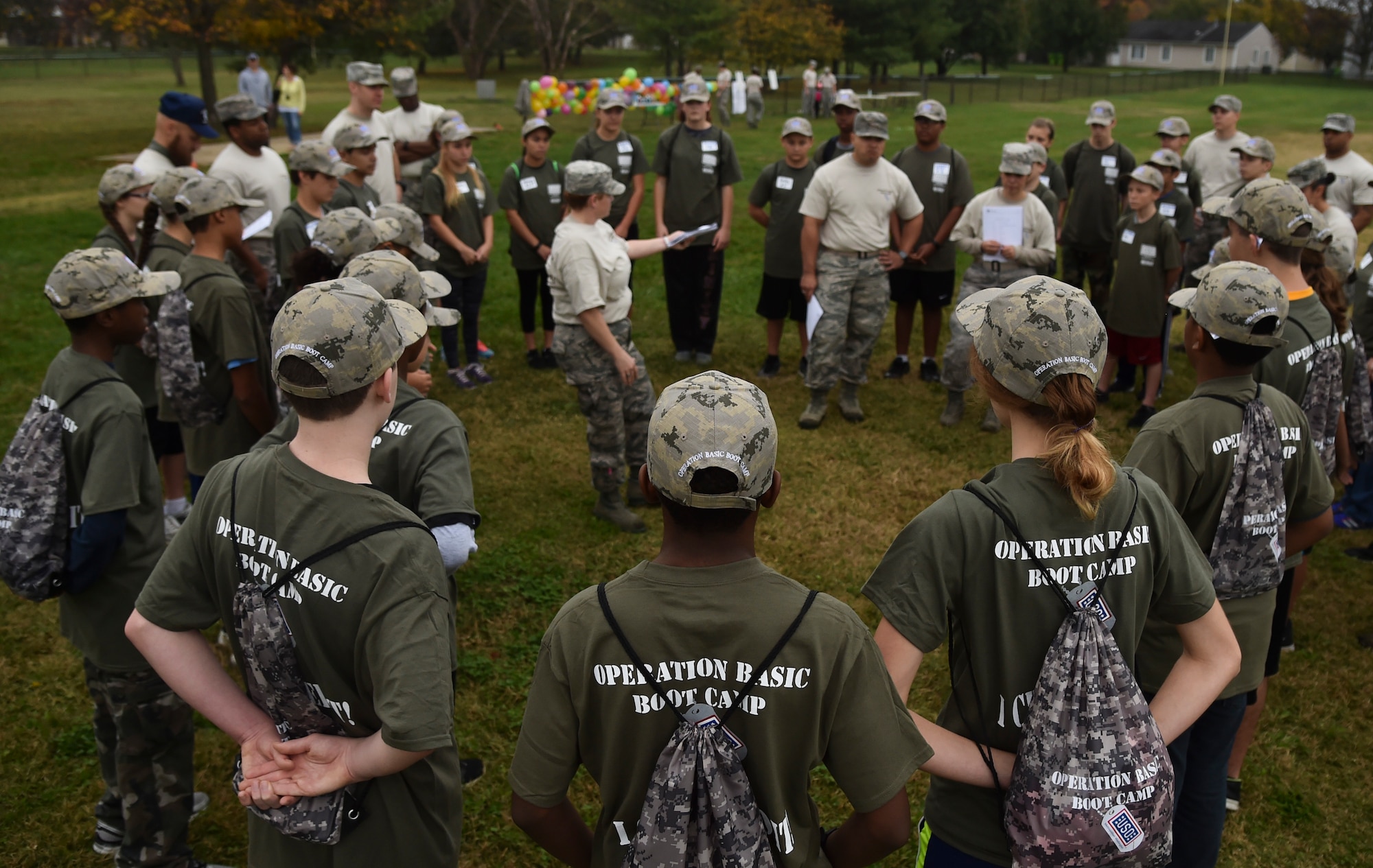 Attendees of Operation Basic Boot Camp stand at parade rest for their morning briefing on Joint Base Andrews, Md., Nov. 7, 2015. The event included physical training, a mock military in-processing station, basic drills and military knowledge classes, a survival class and capture the flag to help military children better understand and appreciate parental military service. (U.S. Air Force photo/ Airman 1st Class J.D. Maidens/ Released)