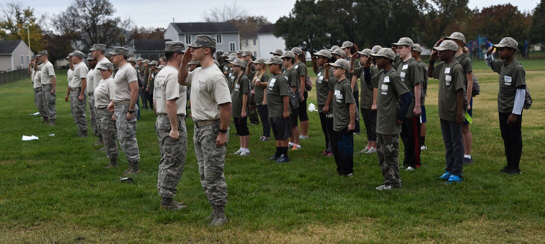 Attendees of Operation Basic Boot Camp stand at attention and learn fundamentals of basic military drill  on Joint Base Andrews, Md., Nov. 7, 2015. The event included physical training, a mock military in-processing station, basic drills and military knowledge classes, a survival class and capture the flag to help military children better understand and appreciate parental military service. (U.S. Air Force photo/ Airman 1st Class J.D. Maidens/ Released)