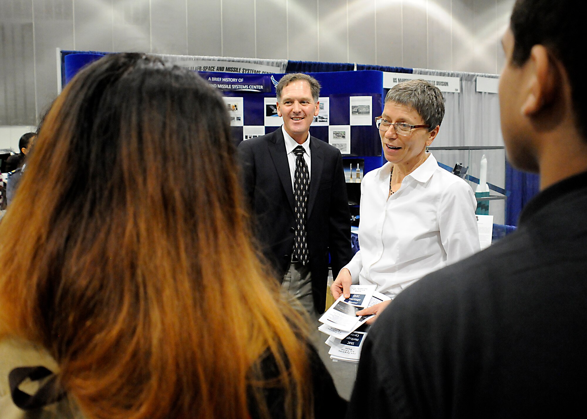 Michael Lane Gilchrist, a contractor with Alpha Omega Group, LLC, working for the Space and Missile Systems Center's Strategic Planning Directorate and Karen Austin from the Space and Missile Systems Center's History Office field questions from Los Angeles Unified School District students Oct. 28-29 during the L.A. Chamber of Commerce-sponsored College career fair at the Los Angeles Convention Center. (U. S. Air Force photo/Joe Juarez Sr.)