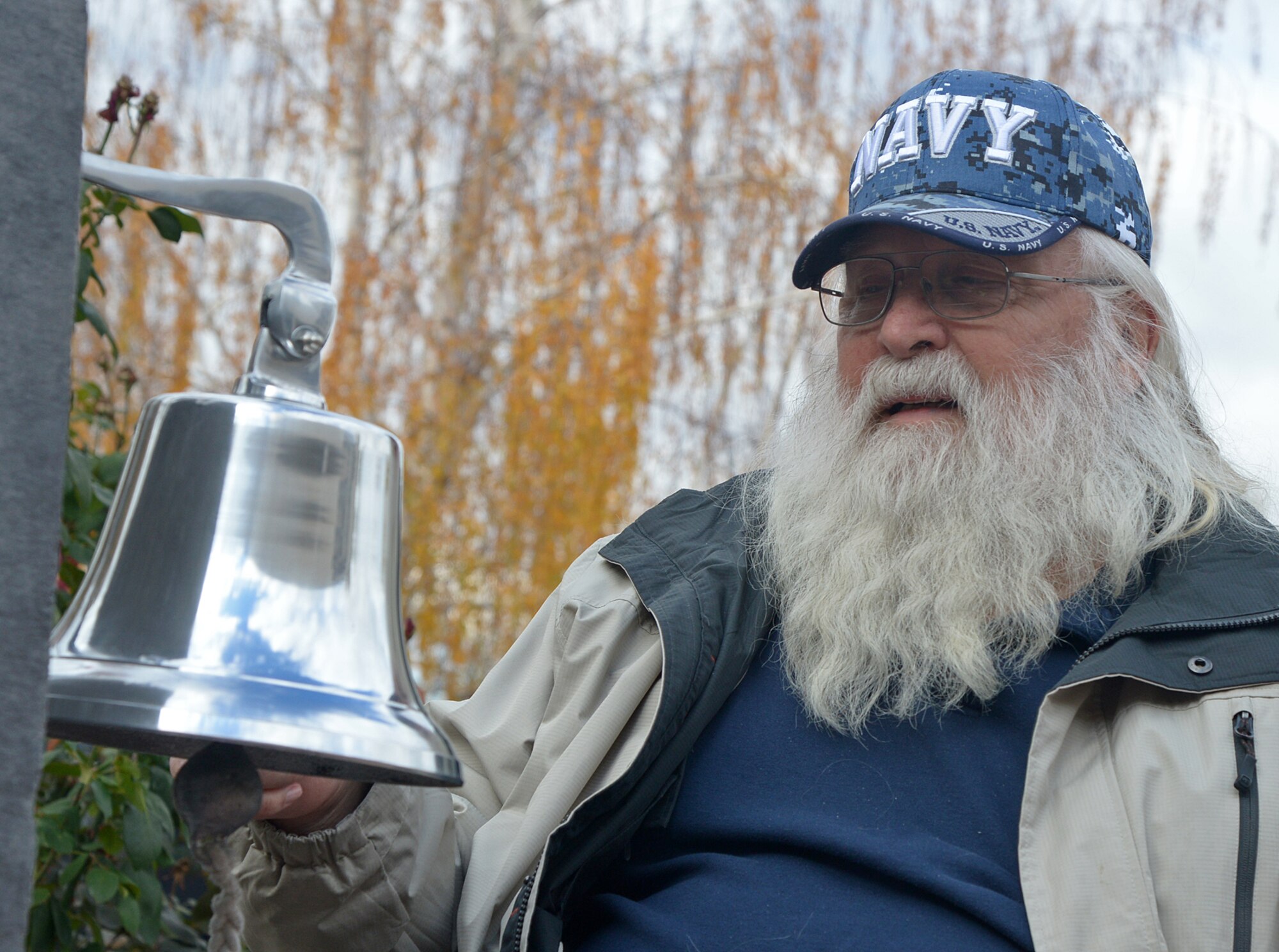Charles Kerkvliet, U.S. Navy and Vietnam veteran, rings the memorial bell during the 2015 Veterans Day memorial service held Nov. 11 at the Riverdale City Offices in Riverdale City, Utah. The bell was rung once for each Riverdale veteran who has passed away since the last service was held in 2014. (U.S. Air Force photo/Alex R. Lloyd)