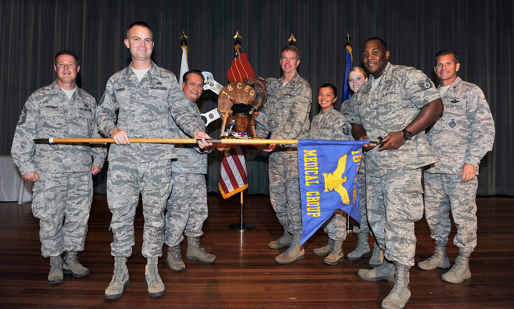 The 18th Medical Group receives the spirit award during Team Kadena's third-quarter awards ceremony at the Keystone Theater, Nov. 10, 2015, at Kadena Air Base, Japan. This award is given to the Team Kadena unit who showed “spirit” in their unit through chants and cheers during the ceremony. (U.S. Air Force photo by Naoto Anazawa)