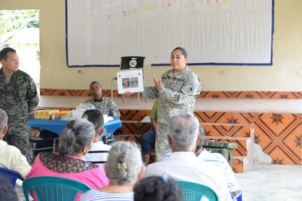 U.S. Army Sgt. Sara Vargas, Joint Task Force-Bravo preventative medicine technician, briefs locals on common symptoms during a medical readiness training exercise, San Jose De Rio Pinto, Honduras, Nov. 12, 2015. Joint Task Force-Bravo partnered with Honduran medical agencies and Non-Governmental agencies to provide people in the area with preventative medical education as well as routine medical and dental procedures. (U.S. Air Force Photo by Senior Airman Westin Warburton/Released)