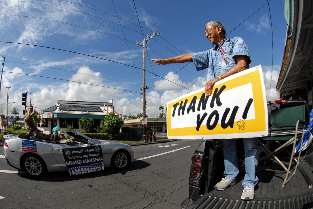 U.S. Army Maj. Gen. Arthur “Joe” Logan, the Adjutant General (TAG) for the State of Hawaii, greets a sign waver during the eighth annual Hawai‘i Island Veterans Day Parade in downtown Hilo, Hawaii, Nov. 7, 2015. Logan was appointed as the Hawaii TAG Jan. 1, 2015. He is a combat veteran with over 36 years of military service and oversees the training and readiness of 5,500 Soldiers and Airmen of the Hawaii National Guard. He is honored along with all veterans during the parade. (U.S. Air National Guard photo by Airman 1st Class Robert Cabuco)