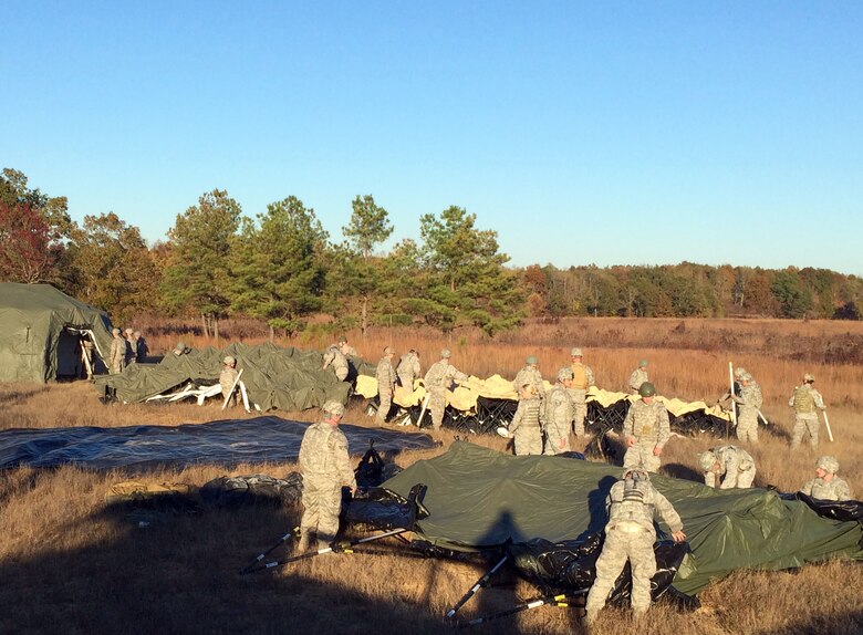 Airmen from the 15th Operational Weather Squadron and the 18th Weather practice building tents during a recent five day field training exercise at Fort Campbell, Kentucky. This was one of many tasks they completed increasing their knowledge of deployment operations. (U.S. Air Force courtesy photo)
