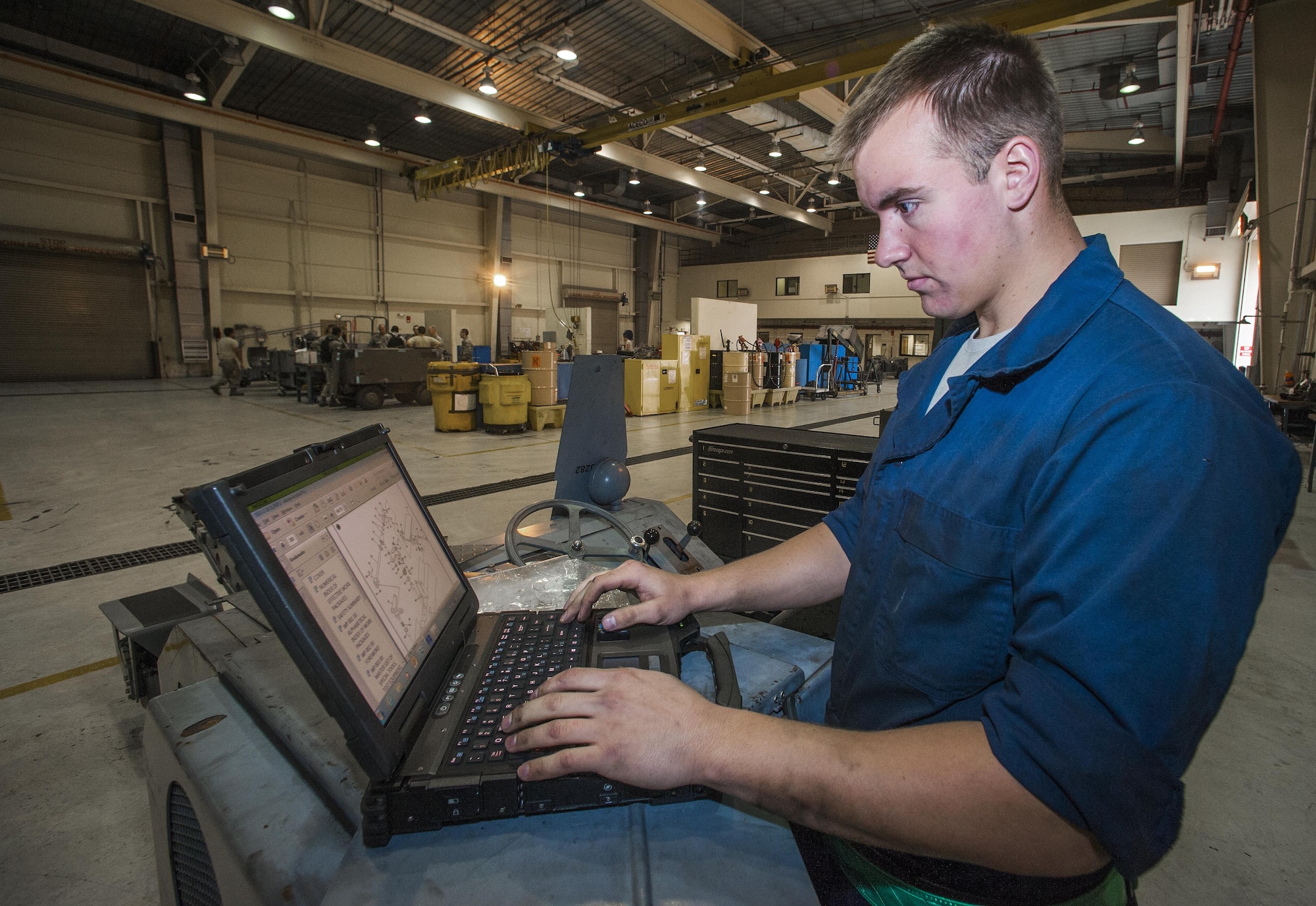 Senior Airman Nicholas Appenzeller, 8th Maintenance Squadron aerospace ground equipment journeyman, checks his technical data as he performs maintenance on a bomb lift at Kunsan Air Base, Republic of Korea, Nov. 10, 2015. The AGE flight maintains equipment that tests, services and troubleshoots aircraft systems while the aircraft is on the ground. (U.S. Air Force photo by Staff Sgt. Nick Wilson/Released)