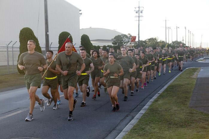 Service members from Headquarters and Headquarters Squadron participate in a formation run aboard Marine Corps Air Station Iwakuni, Japan, Nov 10, 2015. The service members ran in celebration of the Marine Corps' 240th birthday. Approximately 80 participants ran three miles each in a 20 hour period to culminate a total of 237 miles before the squadron commanding officer and sergeant major led the final three miles in a celebratory formation run with squadron service members.