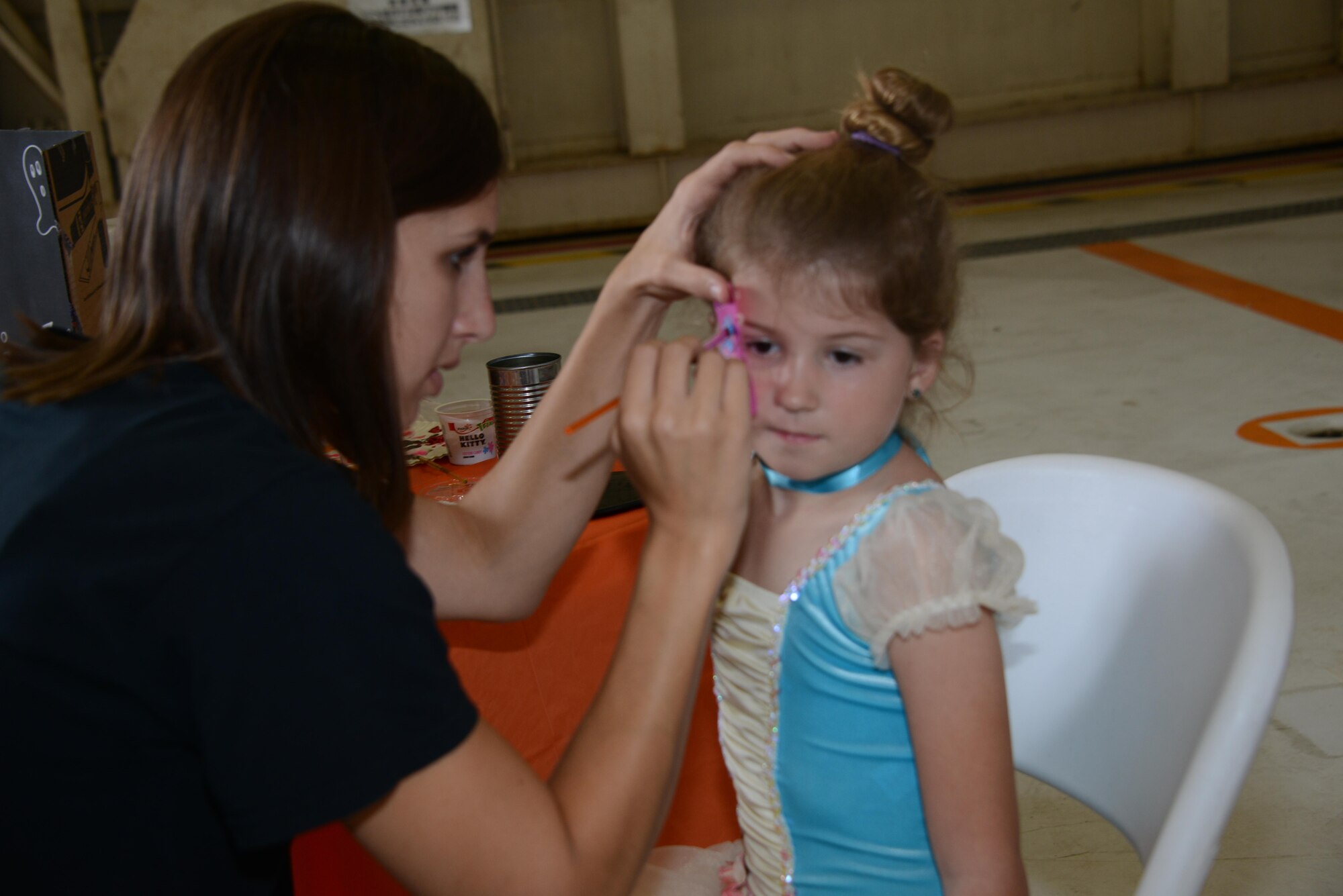 A child from the 353rd Special Operations Group gets her face painted during the 353rd Special Operations Group Fall Festival held Oct. 31, 2015 at Kadena Air Base, Japan.  All five squadrons from the 353rd Special Operations Group came together set up booths with games, activities and food for the children of the 353rd Special Operations Group.  (U.S. Air Force photo by Tech. Sgt. Kristine Dreyer)
