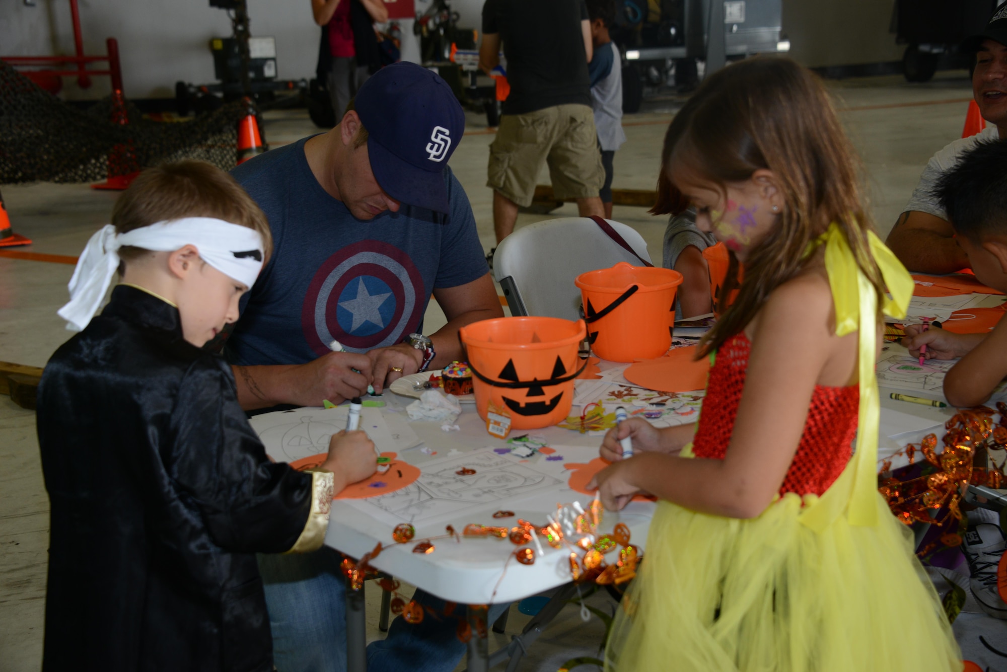 Participants complete fall crafts during the 353rd Special Operations Group Fall Festival held Oct. 31, 2015 at Kadena Air Base, Japan.  All five squadrons from the 353rd Special Operations Group came together set up booths with games, activities and food for the children of the 353rd Special Operations Group.  (U.S. Air Force photo by Tech. Sgt. Kristine Dreyer)