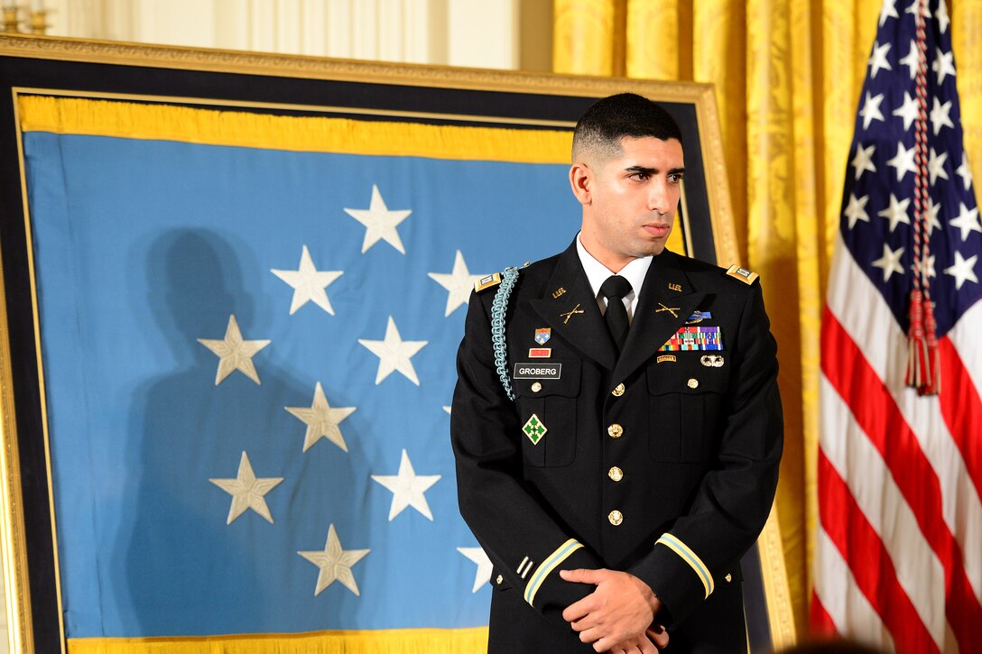 Retired Army Capt. Florent A. Groberg listens as President Barack Obama addresses the audience during his Medal of Honor ceremony at the White House, Nov. 12, 2015. U.S. Army photo by Eboni L. Everson-Myart    