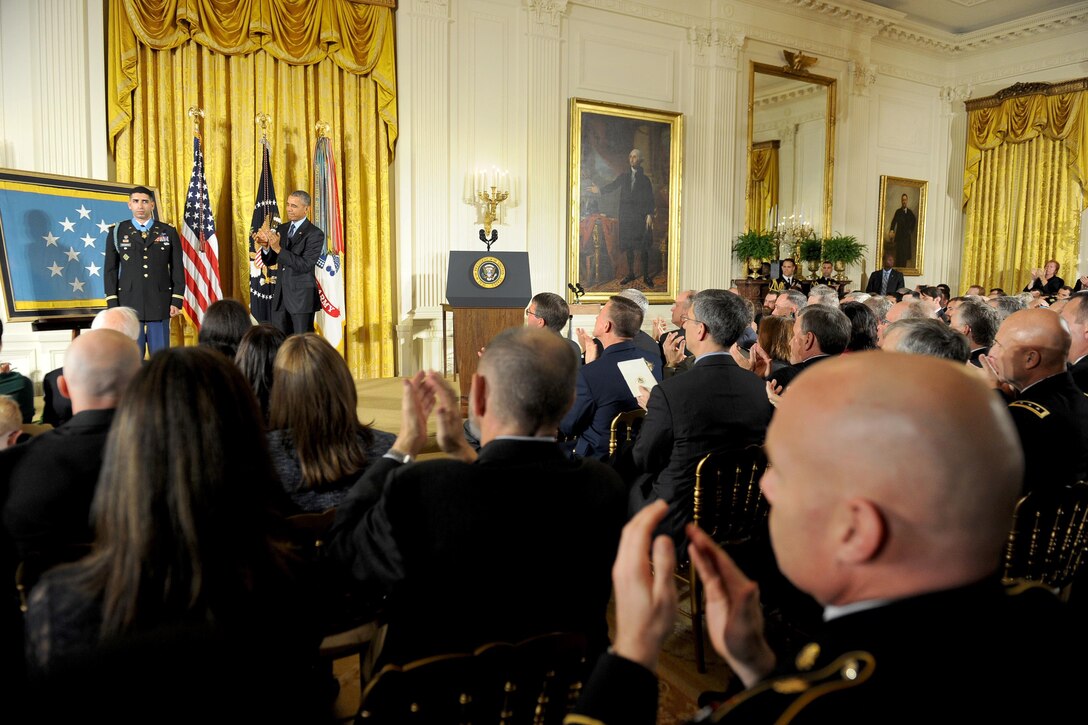 President Barack Obama and the audience applaud retired Army Capt. Florent A. Groberg during his Medal of Honor ceremony at the White House, Nov. 12, 2015. U.S. Army photo by Eboni L. Everson-Myart 