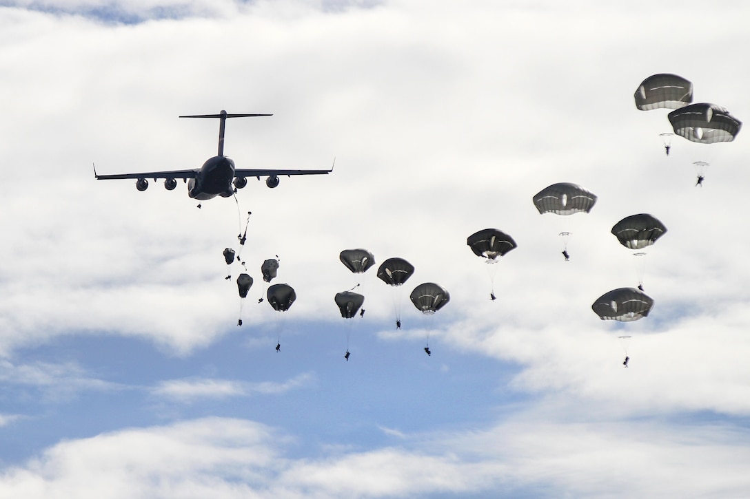 U.S. paratroopers parachute from C-17 Globemaster III aircraft for joint forcible entry training during Operation Trident Juncture near San Gregorio, Spain, Nov. 4, 2015. The paratroopers are assigned to the 82nd Airborne Division’s 2nd Brigade Combat Team. U.S. Army photo by Staff Sgt. Jason Hull