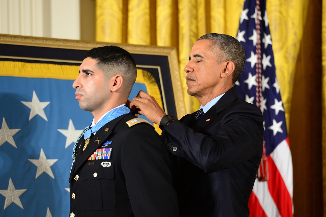 President Barack Obama presents the Medal of Honor to retired Army Capt. Florent A. Groberg during a ceremony at the White House, Nov. 12, 2015. Groberg received the medal for actions during a combat engagement in Kunar province, Afghanistan, Aug. 8, 2012, while he was the commander of a personal security detail for the 4th Brigade Combat Team, 4th Infantry Division. He and another soldier, Army Sgt. Andrew Mahoney, identified and tackled a suicide bomber, saving the lives of the brigade commander and several others. U.S. Army photo by Eboni L. Everson-Myart