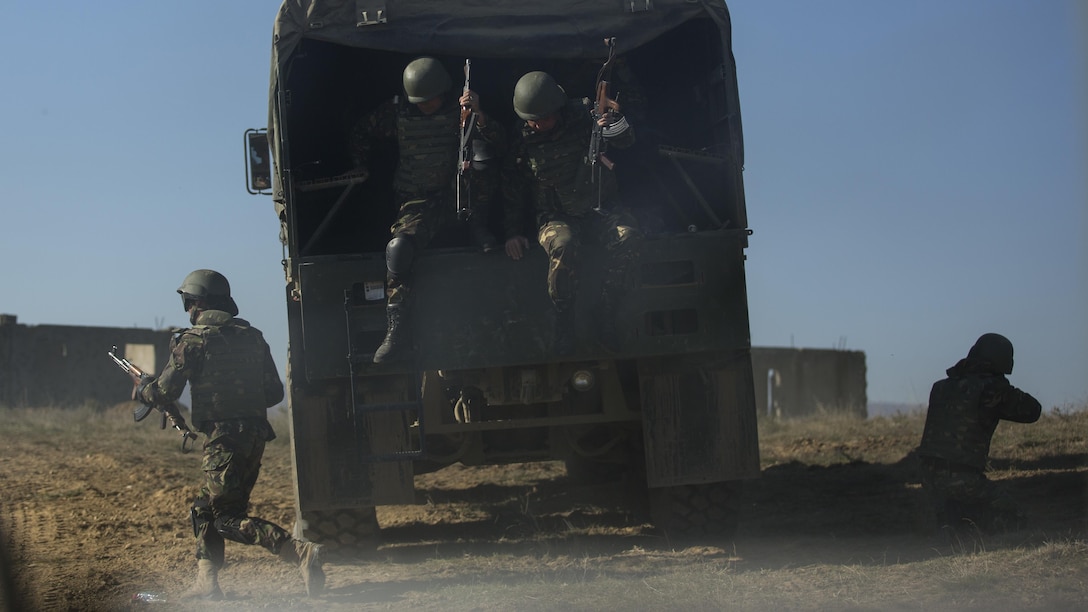 Romanian Armed Forces clear a Military Operations in Urban Terrain facility with support from Bulgarian BMP-1s during the final exercise of Platinum Lion 16-1 at Novo Selo Training Area, Bulgaria, Nov. 7, 2015. Platinum Lion, the first multinational live-fire engagement in which the Combined Arms Company participated, is a NATO-led exercise designed to increase readiness and build partner capacity through realistic combat scenarios and objective-focused training. 