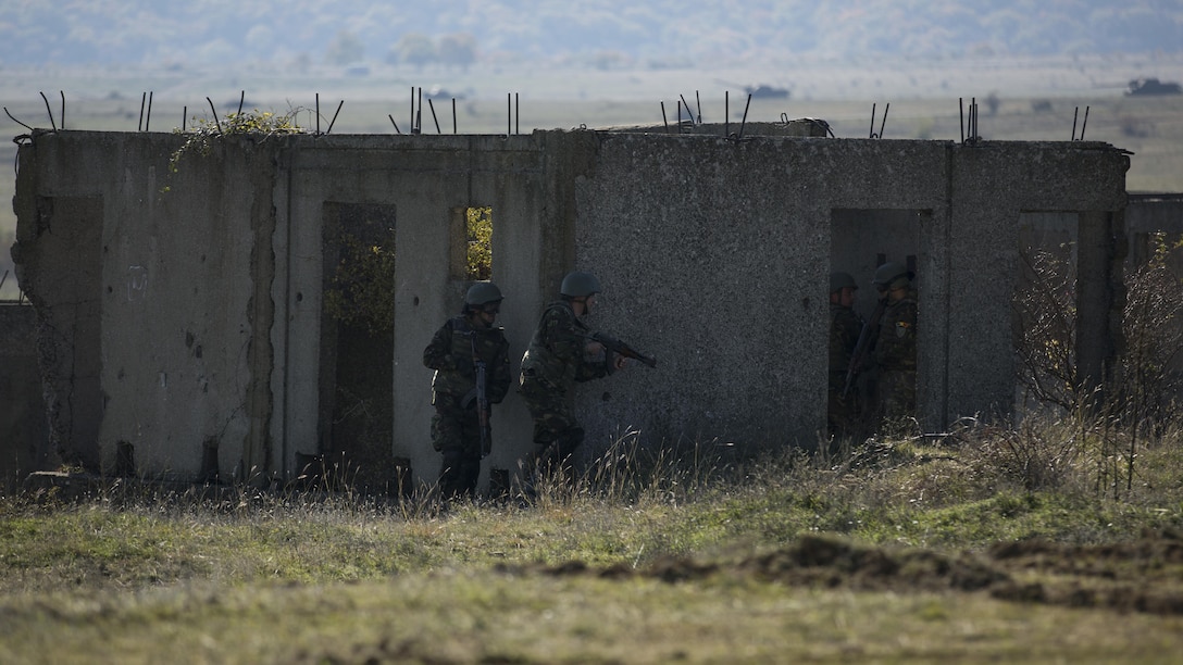 Romanian Armed Forces clear a Military Operations in Urban Terrain facility with support from Bulgarian BMP-1s during the final exercise of Platinum Lion 16-1 at Novo Selo Training Area, Bulgaria, Nov. 7, 2015. Platinum Lion, the first multinational live-fire engagement in which the Combined Arms Company participated, is a NATO-led exercise designed to increase readiness and build partner capacity through realistic combat scenarios and objective-focused training. 