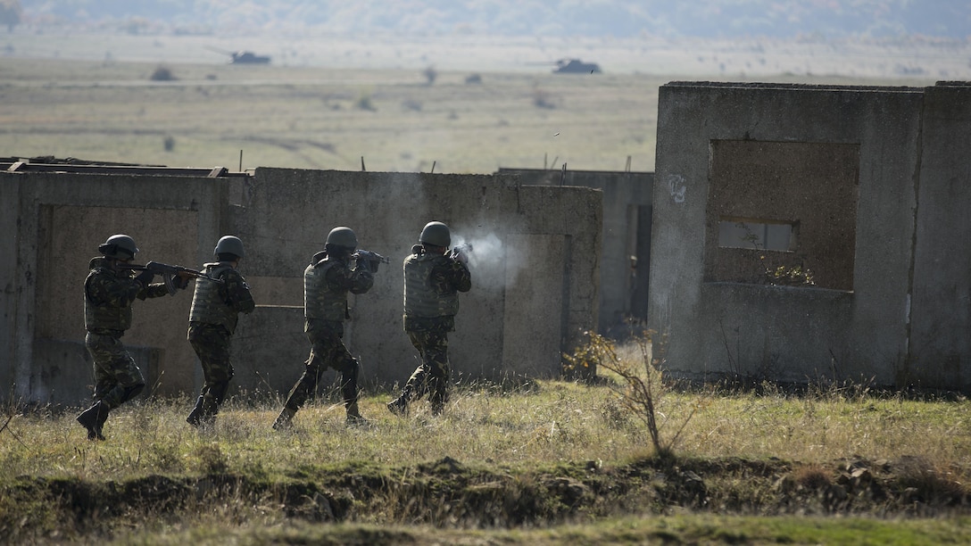Romanian Armed Forces clear a Military Operations in Urban Terrain facility with support from Bulgarian BMP-1s during the final exercise of Platinum Lion 16-1 at Novo Selo Training Area, Bulgaria, Nov. 7, 2015. Platinum Lion, the first multinational live-fire engagement in which the Combined Arms Company participated, is a NATO-led exercise designed to increase readiness and build partner capacity through realistic combat scenarios and objective-focused training. 