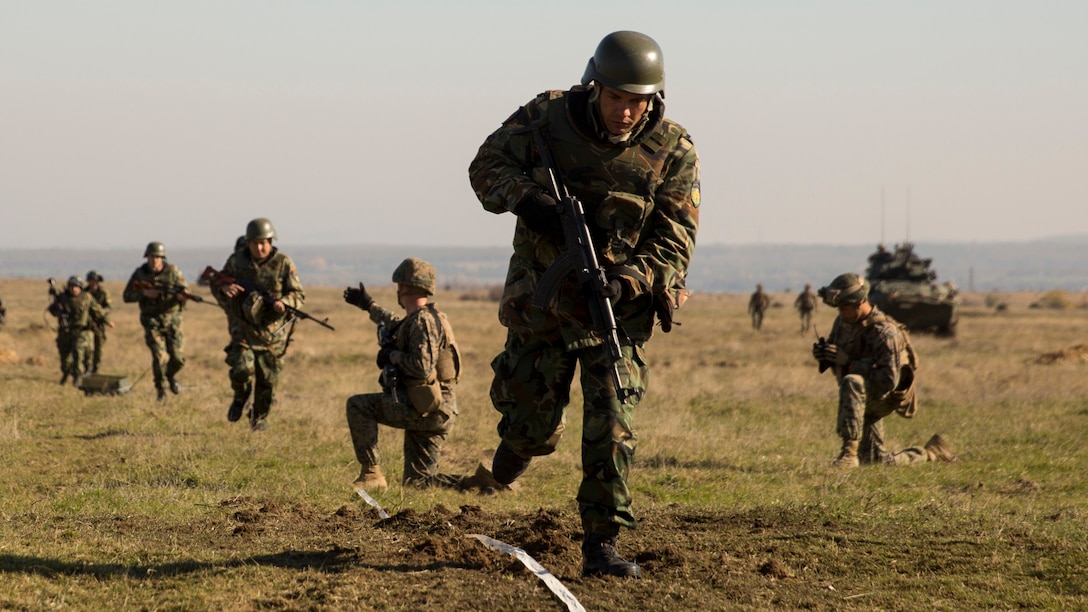 Bulgarian Armed Forces maneuver through the lane cleared by the Combined Arms Company Marines, allowing them to continue toward the objective during the final exercise of Platinum Lion 16-1 at Novo Selo Training Area, Bulgaria, Nov. 7, 2015. Platinum Lion, the first multinational live-fire engagement in which the Combined Arms Company participated, is a NATO-led exercise designed to increase readiness and build partner capacity through realistic combat scenarios and objective-focused training. 