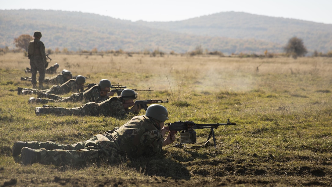Bulgarian Armed Forces maneuver through the lane cleared by the Combined Arms Company Marines, allowing them to continue toward the objective during the final exercise of Platinum Lion 16-1 at Novo Selo Training Area, Bulgaria, Nov. 7, 2015. Platinum Lion, the first multinational live-fire engagement in which the Combined Arms Company participated, is a NATO-led exercise designed to increase readiness and build partner capacity through realistic combat scenarios and objective-focused training. 
