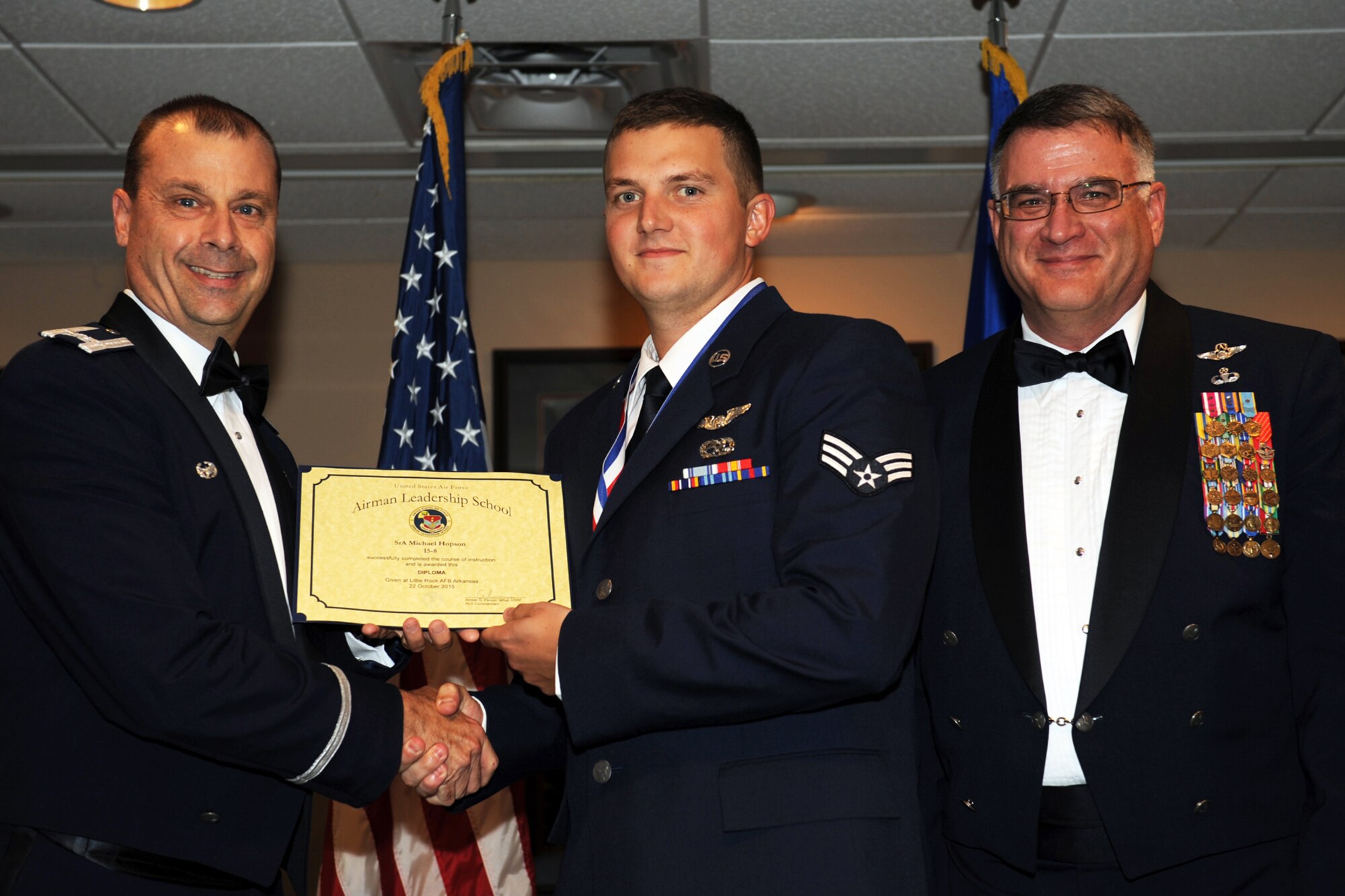 U.S. Air Force Col. Craig Drescher, 913th Airlift Group commander, poses for a photo with Senior Airman Michael Hopson, flight engineer, 327th Airlift Squadron, during the Airman Leadership School graduation ceremony at Little Rock Air Force base, Ark., Oct. 22, 2015. Hopson and his fellow graduates will soon become the Air Force’s newest noncommissioned officers. (U.S. Air Force photo by Senior Airman Harry Brexel/Released)