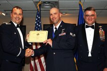 U.S. Air Force Col. Craig Drescher, 913th Airlift Group commander, poses for a photo with Senior Airman Aaron Broge, who is assigned to the 327th Airlift Squadron, during the Airman Leadership School graduation ceremony at Little Rock Air Force base, Ark., Oct. 22, 2015. Broge and his fellow graduates will soon become the Air Force’s newest noncommissioned officers. (U.S. Air Force photo by Senior Airman Harry Brexel/Released)