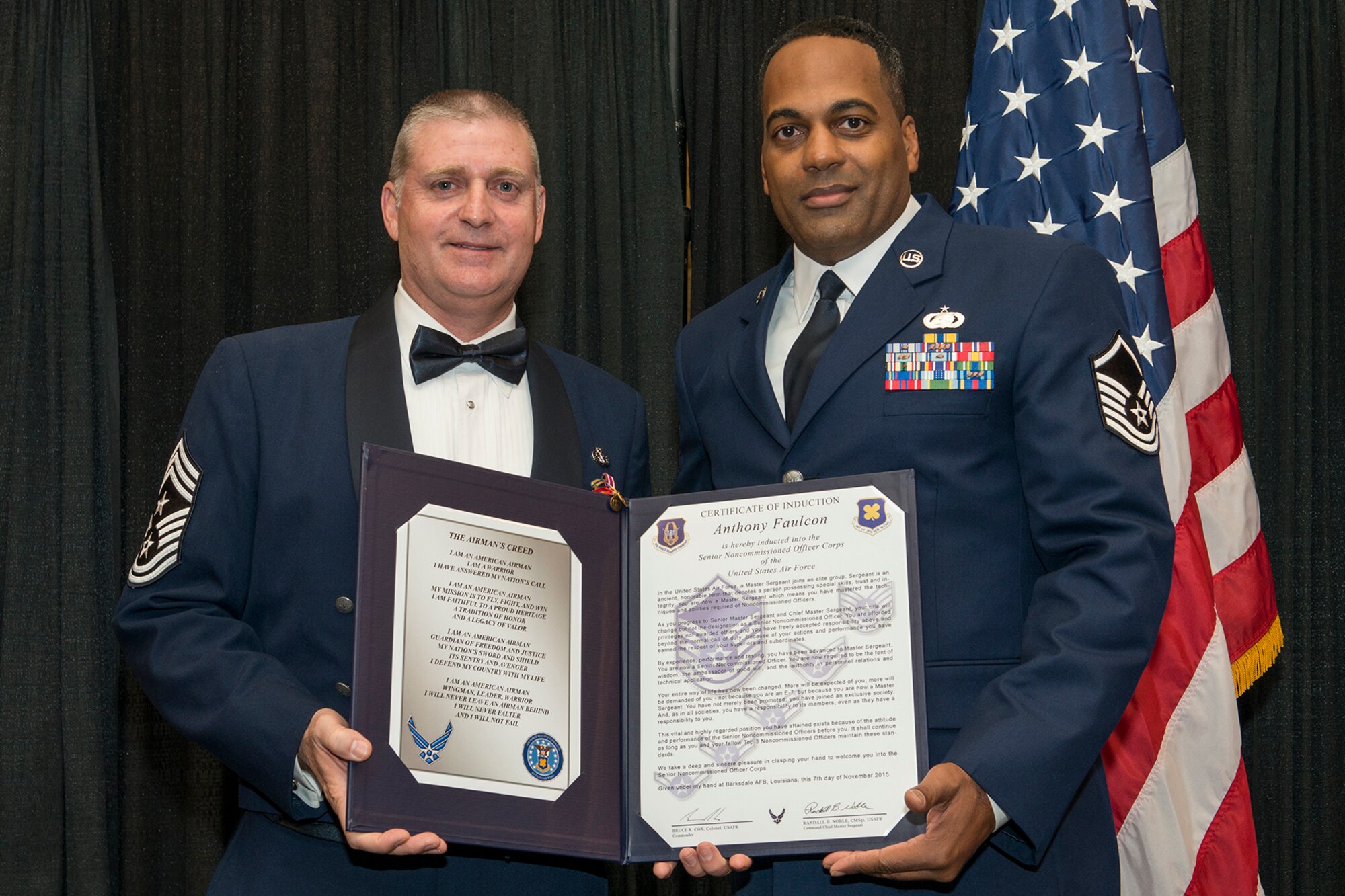 U.S. Air Force Master Sgt. Anthony Faulcon is presented the Certificate of Induction during a ceremony on Nov. 7, 2015, Shreveport, La. The 307th Bomb Wing Senior Noncommissioned Officer Induction Ceremony is an annual event held to recognize Airmen who were recently promoted to the rank of Master Sergeant. (U.S. Air Force photo by Master Sgt. Greg Steele/Released)