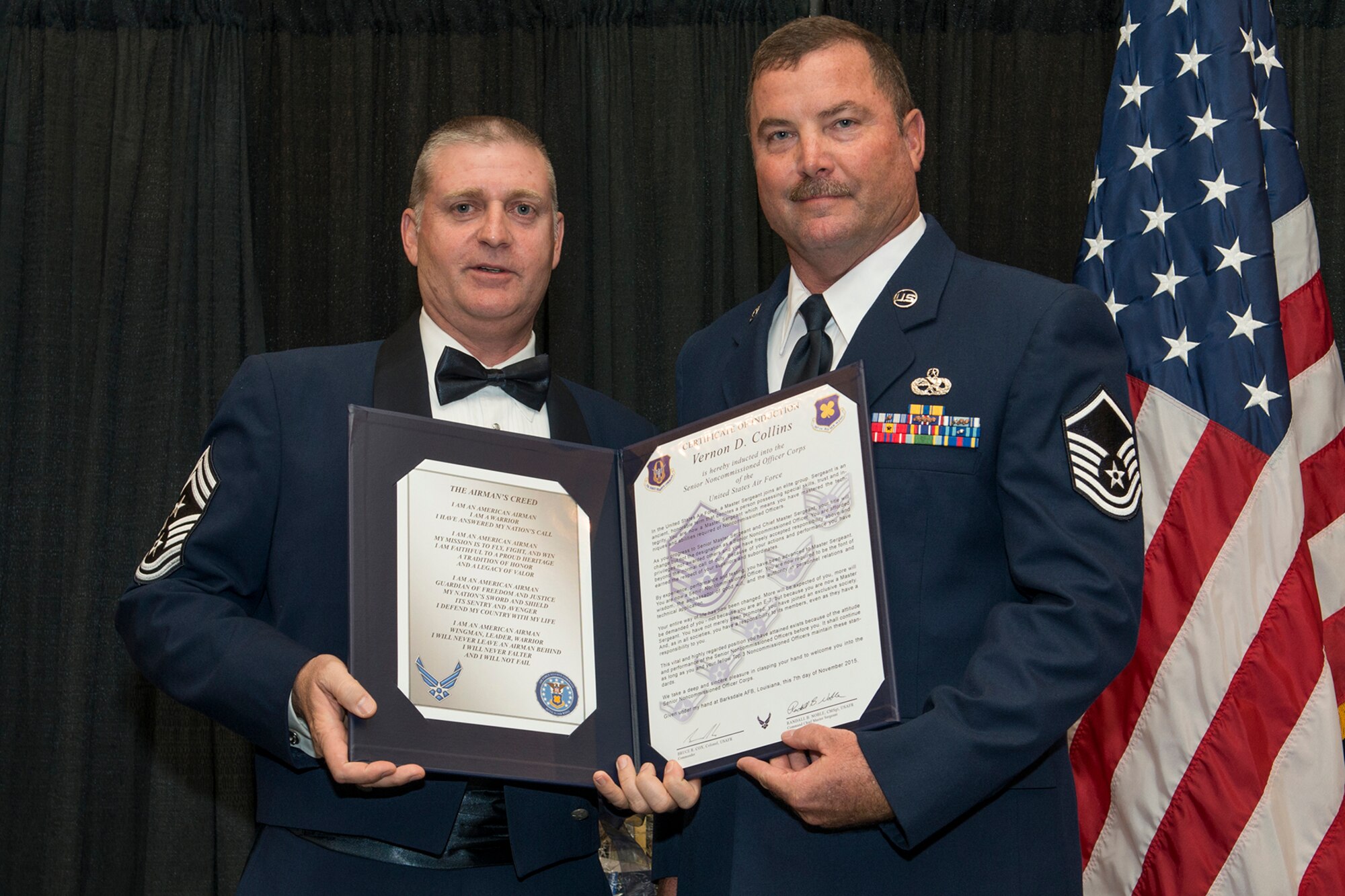 U.S. Air Force Master Sgt. Vernon Collins is presented the Certificate of Induction during a ceremony on Nov. 7, 2015, Shreveport, La. The 307th Bomb Wing Senior Noncommissioned Officer Induction Ceremony is an annual event held to recognize Airmen who were recently promoted to the rank of Master Sergeant. (U.S. Air Force photo by Master Sgt. Greg Steele/Released)