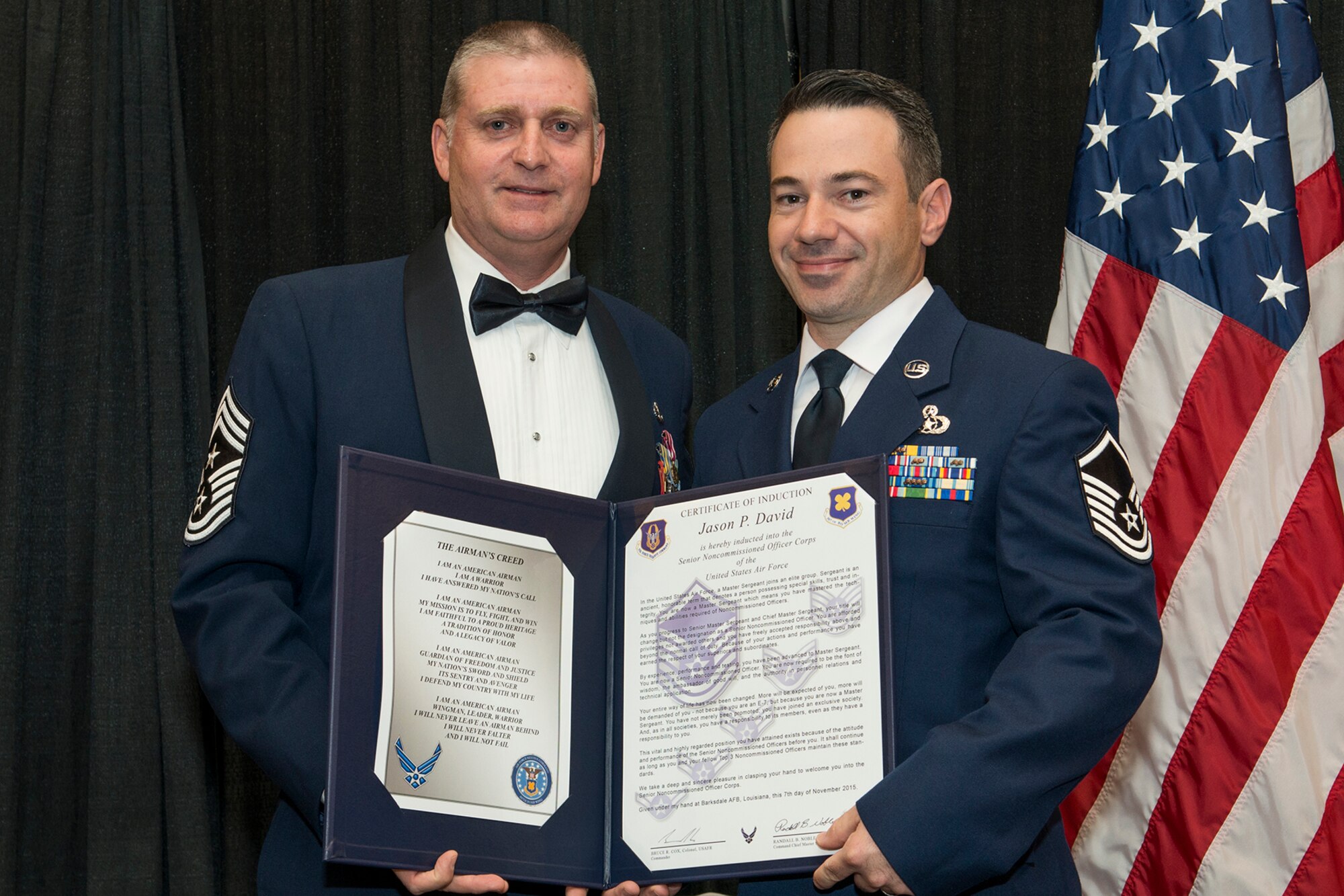 U.S. Air Force Master Sgt. Jason David is presented the Certificate of Induction during a ceremony on Nov. 7, 2015, Shreveport, La. The 307th Bomb Wing Senior Noncommissioned Officer Induction Ceremony is an annual event held to recognize Airmen who were recently promoted to the rank of Master Sergeant. (U.S. Air Force photo by Master Sgt. Greg Steele/Released)