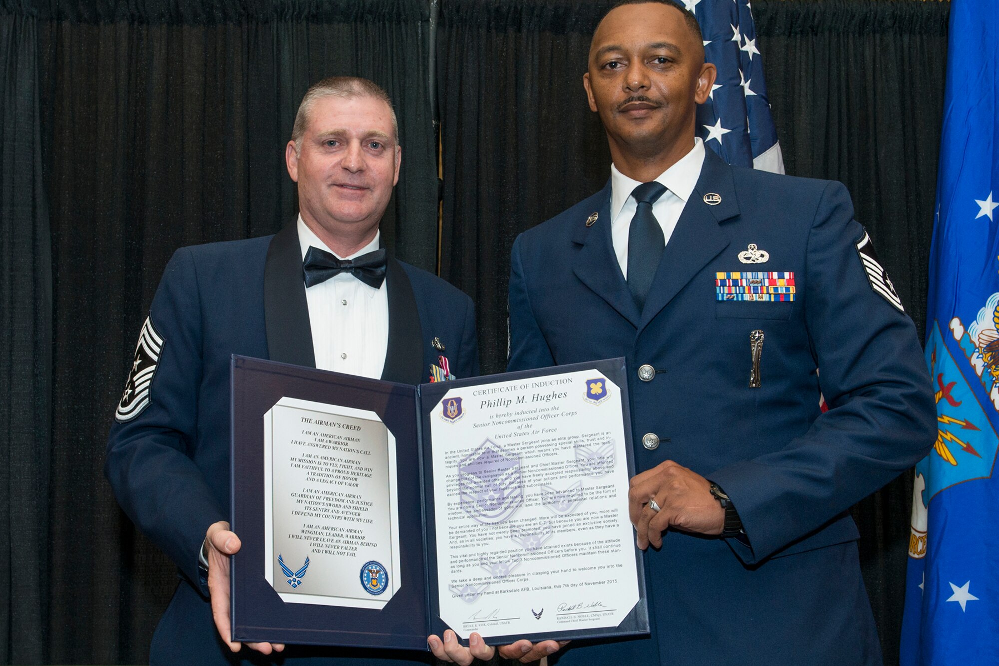 U.S. Air Force Master Sgt. Phillip Hughes is presented the Certificate of Induction during a ceremony on Nov. 7, 2015, Shreveport, La. The 307th Bomb Wing Senior Noncommissioned Officer Induction Ceremony is an annual event held to recognize Airmen who were recently promoted to the rank of Master Sergeant. (U.S. Air Force photo by Master Sgt. Greg Steele/Released)