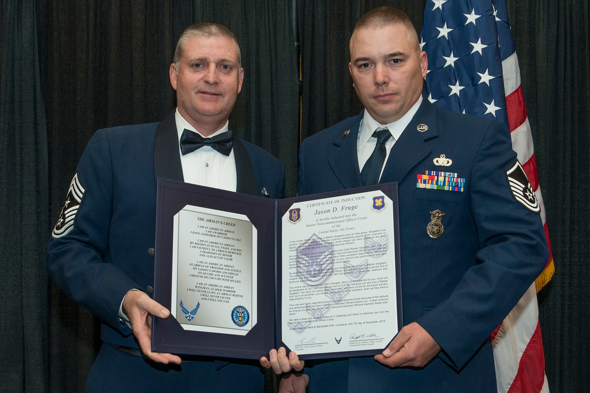 U.S. Air Force Master Sgt. Jason Fruge is presented the Certificate of Induction during a ceremony on Nov. 7, 2015, Shreveport, La. The 307th Bomb Wing Senior Noncommissioned Officer Induction Ceremony is an annual event held to recognize Airmen who were recently promoted to the rank of Master Sergeant. (U.S. Air Force photo by Master Sgt. Greg Steele/Released)
