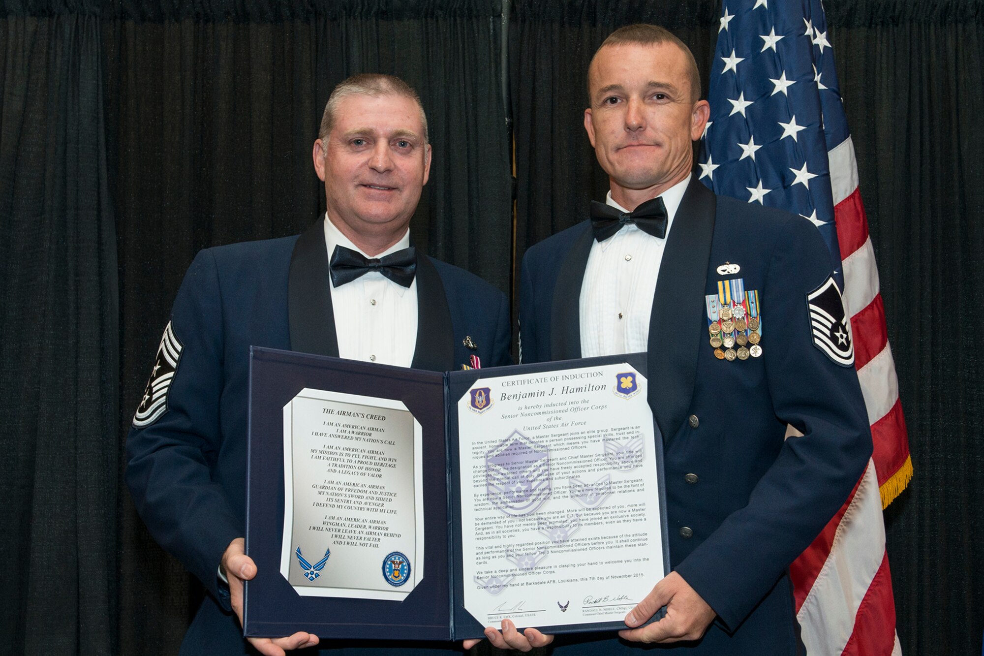 U.S. Air Force Master Sgt. Benjamin Hamilton is presented the Certificate of Induction during a ceremony on Nov. 7, 2015, Shreveport, La. The 307th Bomb Wing Senior Noncommissioned Officer Induction Ceremony is an annual event held to recognize Airmen who were recently promoted to the rank of Master Sergeant. (U.S. Air Force photo by Master Sgt. Greg Steele/Released)