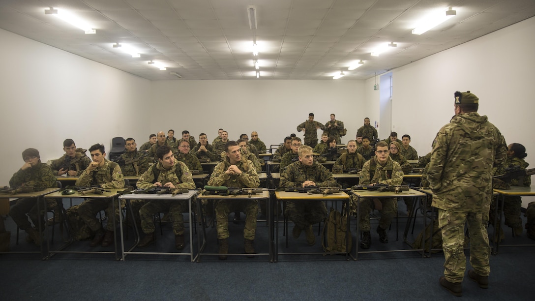 U.S. Marines with 2nd Intelligence Battalion and British soldiers attend a brief before firing at a range in Edinburgh, U.K., Nov. 4, 2015. The forces partnered for Exercise Phoenix Odyssey II, which was designed to bolster joint intelligence operations and build on basic military skills.