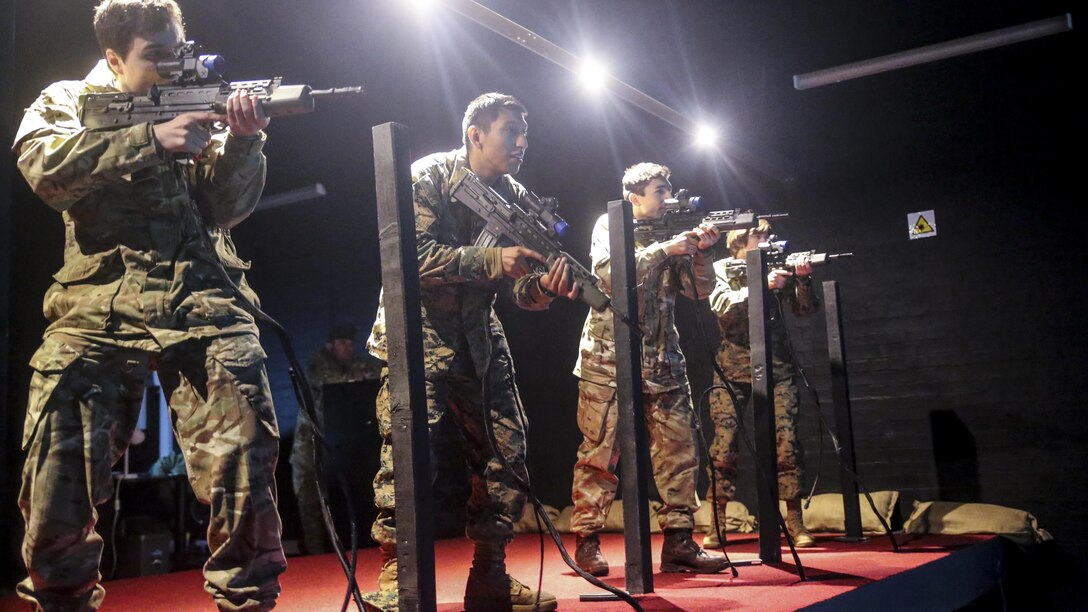U.S. Marines with 2nd Intelligence Battalion and British soldiers rehearse combat scenarios at a Digital Combat Simulator in Edinburgh, U.K., Nov. 4, 2015. These scenarios help service members practice their shooting, communication and decision making skills to better prepare them for real life confrontations, and ultimately enhance interoperability. The forces conducted Exercise Phoenix Odyssey II which helped increase joint intelligence operations and military skills.