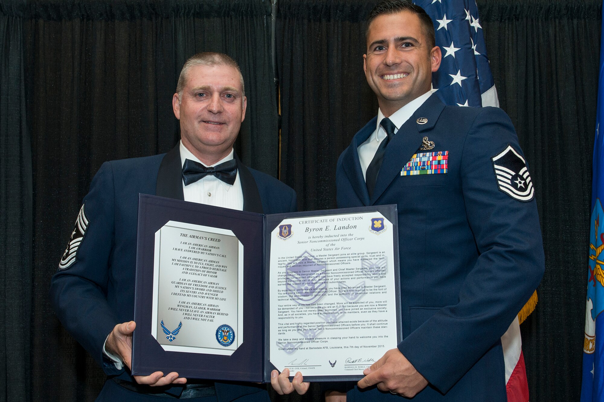 U.S. Air Force Master Sgt. Byron Landon is presented the Certificate of Induction during a ceremony on Nov. 7, 2015, Shreveport, La. The 307th Bomb Wing Senior Noncommissioned Officer Induction Ceremony is an annual event held to recognize Airmen who were recently promoted to the rank of Master Sergeant. (U.S. Air Force photo by Master Sgt. Greg Steele/Released)
