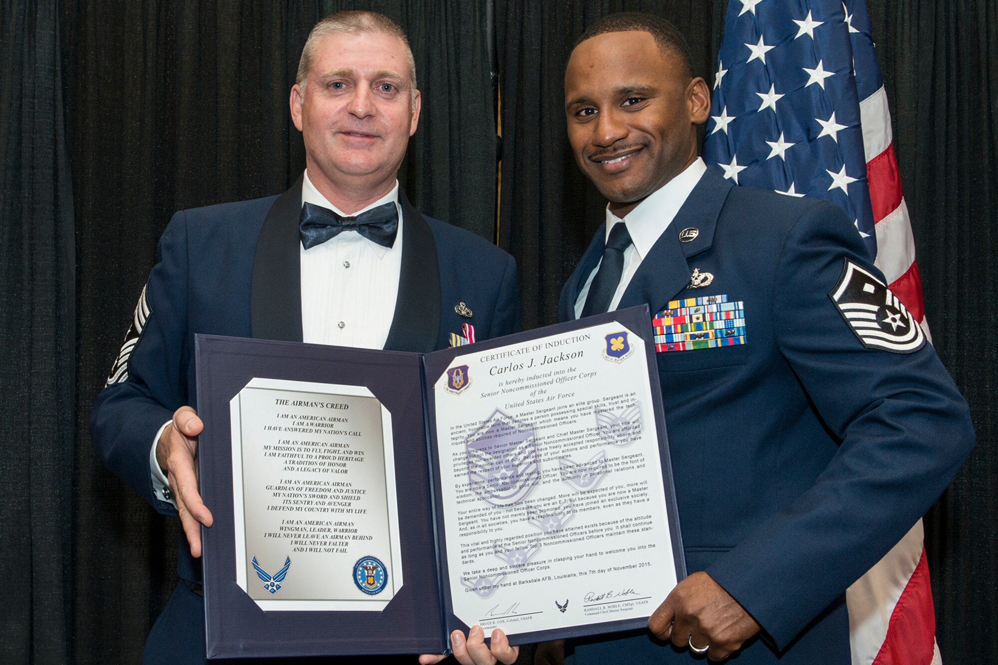 U.S. Air Force Master Sgt. Carlos Jackson is presented the Certificate of Induction during a ceremony on Nov. 7, 2015, Shreveport, La. The 307th Bomb Wing Senior Noncommissioned Officer Induction Ceremony is an annual event held to recognize Airmen who were recently promoted to the rank of Master Sergeant. (U.S. Air Force photo by Master Sgt. Greg Steele/Released)