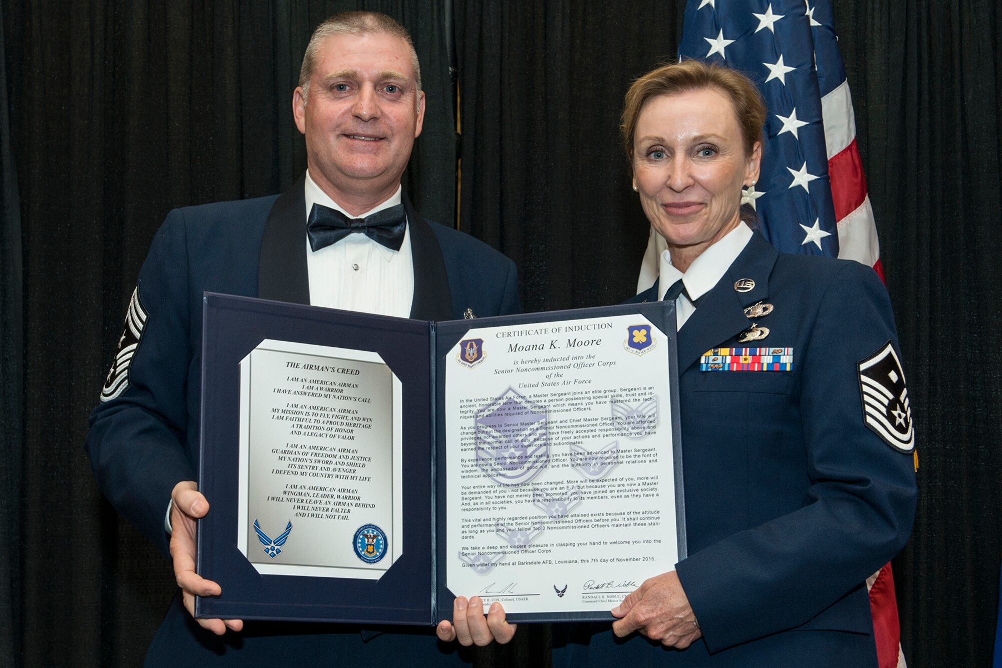 U.S. Air Force Master Sgt. Moana Moore is presented the Certificate of Induction during a ceremony on Nov. 7, 2015, Shreveport, La. The 307th Bomb Wing Senior Noncommissioned Officer Induction Ceremony is an annual event held to recognize Airmen who were recently promoted to the rank of Master Sergeant. (U.S. Air Force photo by Master Sgt. Greg Steele/Released)